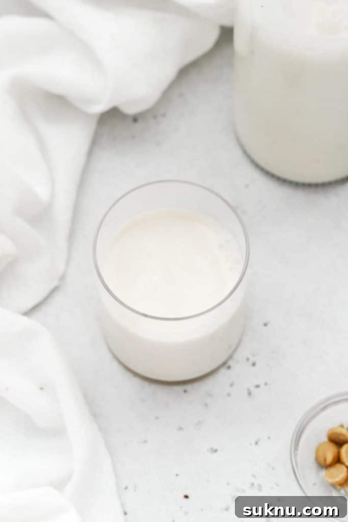 almond milk in a glass, ready to dip cookies