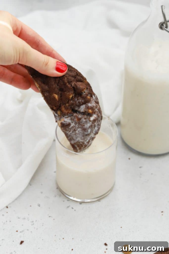 Dipping a gluten-free chocolate peanut butter chip cookie in almond milk