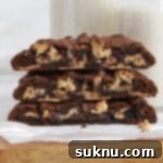 Front view of gluten-free Levain-style dark chocolate peanut butter chip cookies, revealing their gooey center