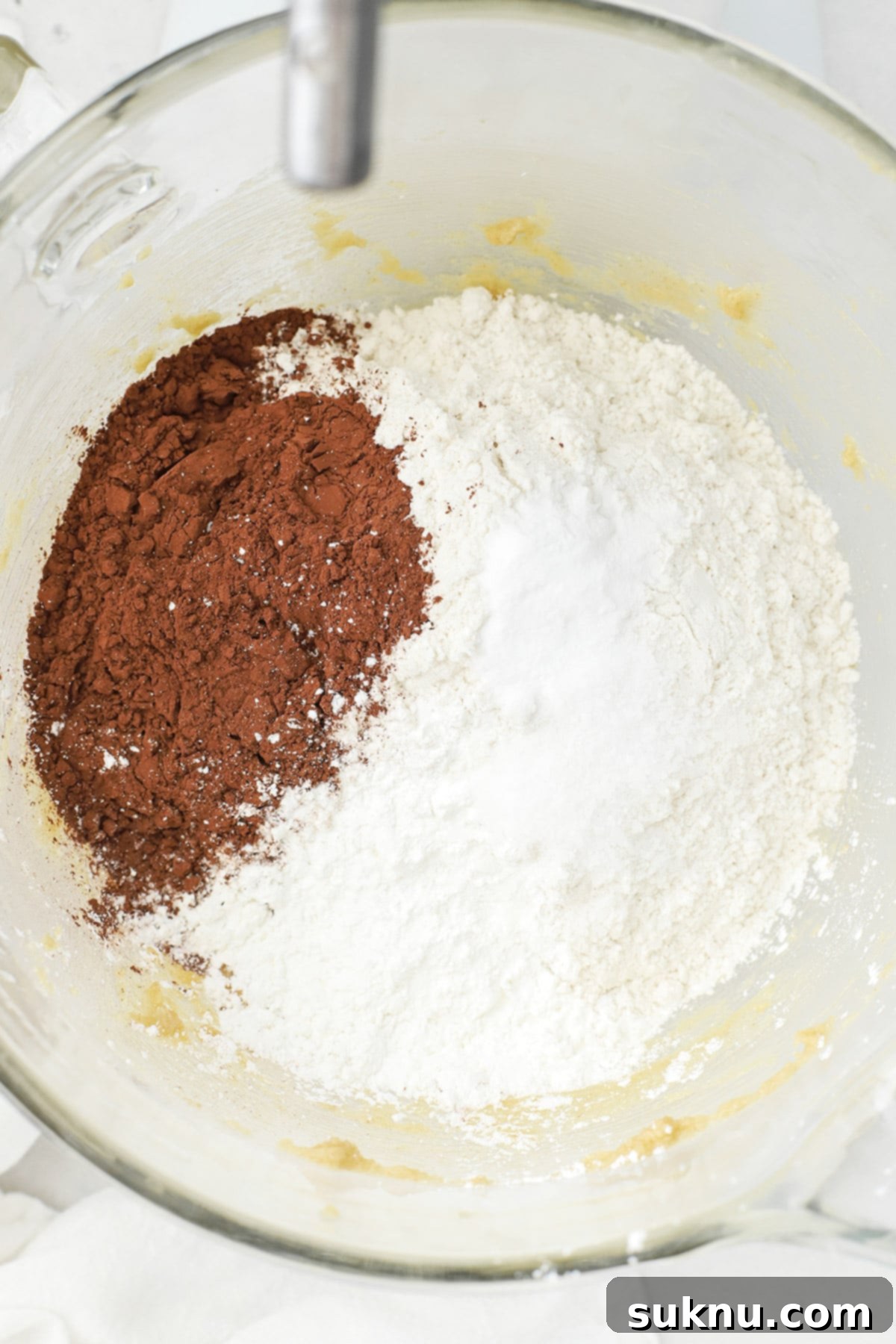 Adding dry ingredients to the dough for gluten-free Levain-style dark chocolate peanut butter chip cookies