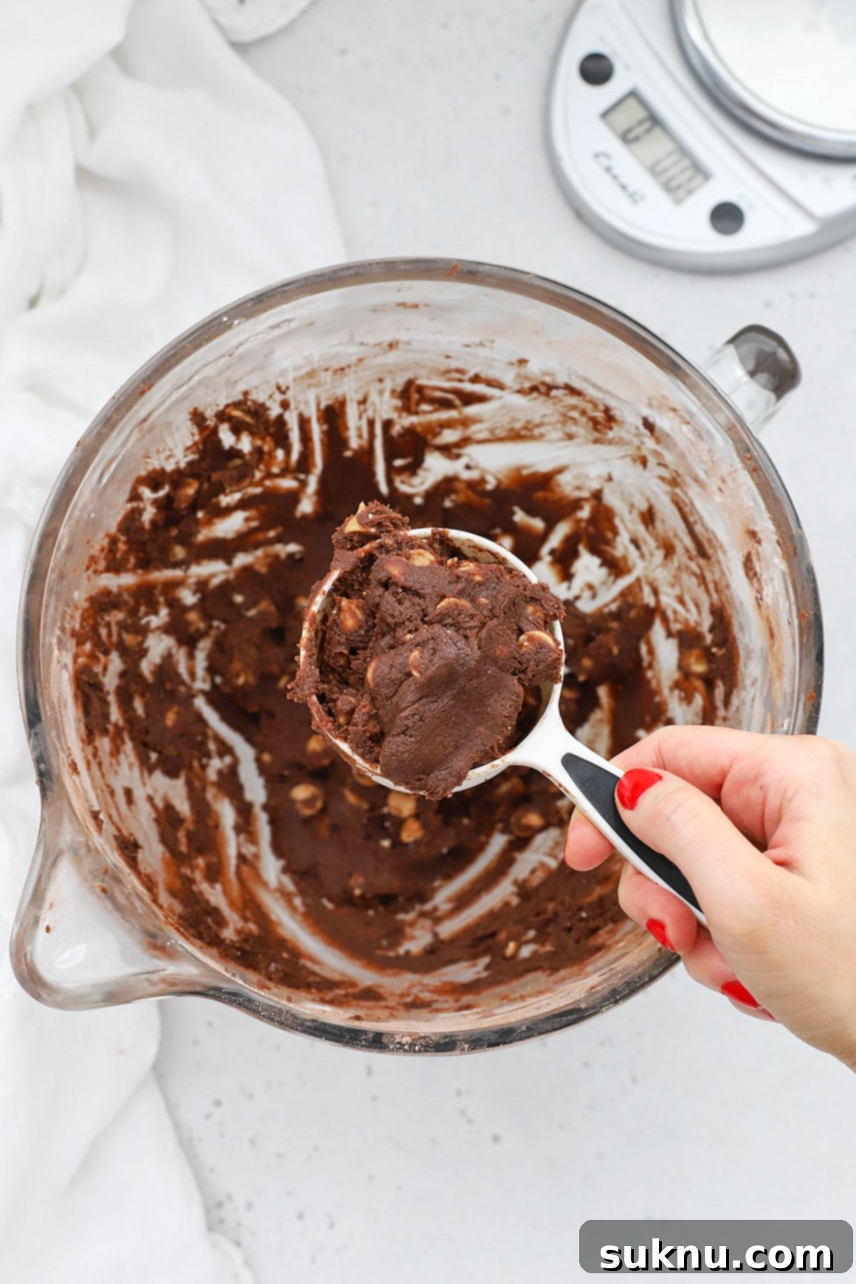 Scooping chocolate peanut butter chip cookie dough