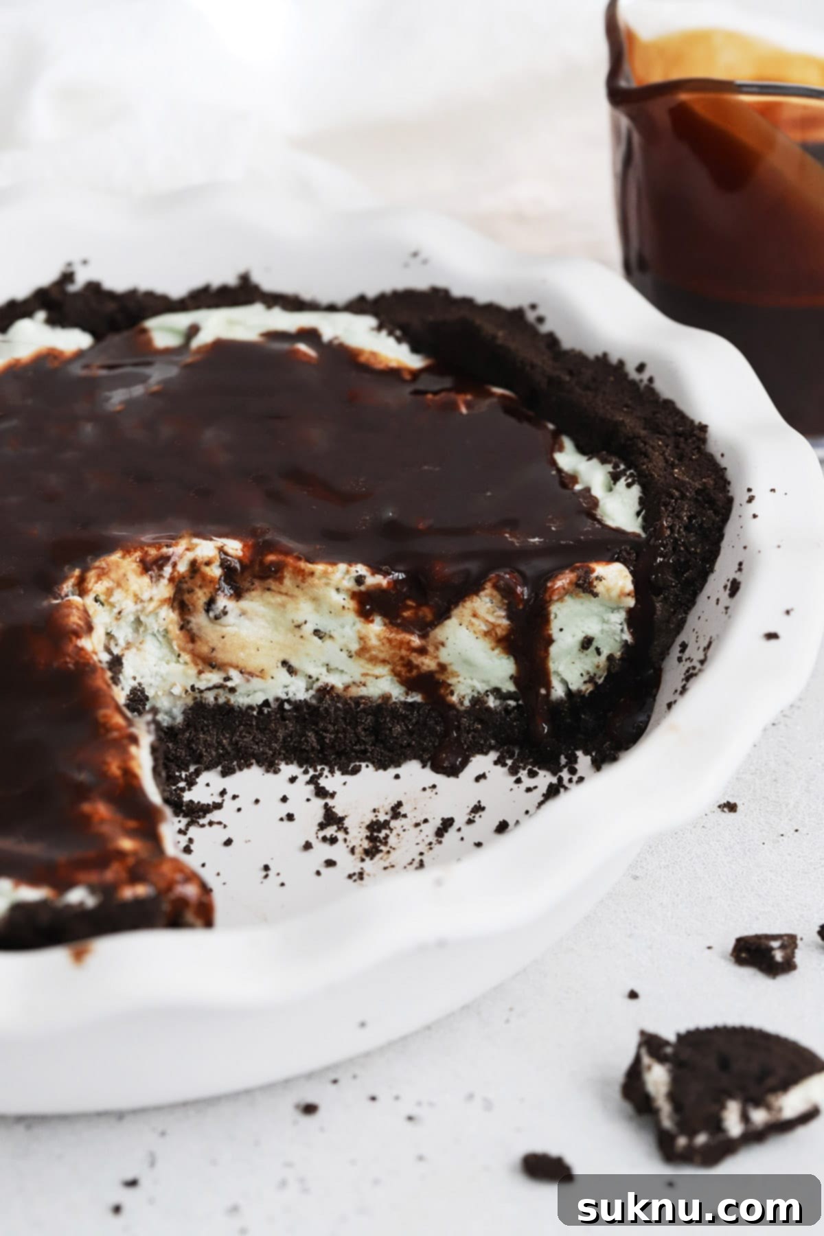 Front view of a gluten-free grasshopper pie covered with chocolate sauce