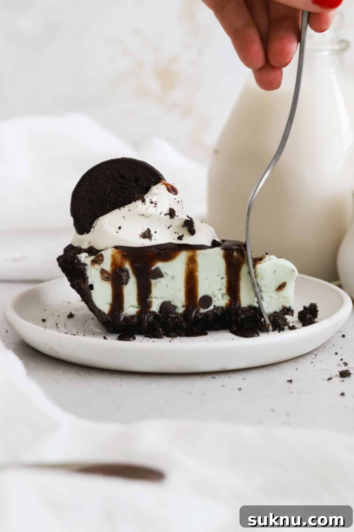 fork cutting into a slice of mint chocolate chip ice cream pie
