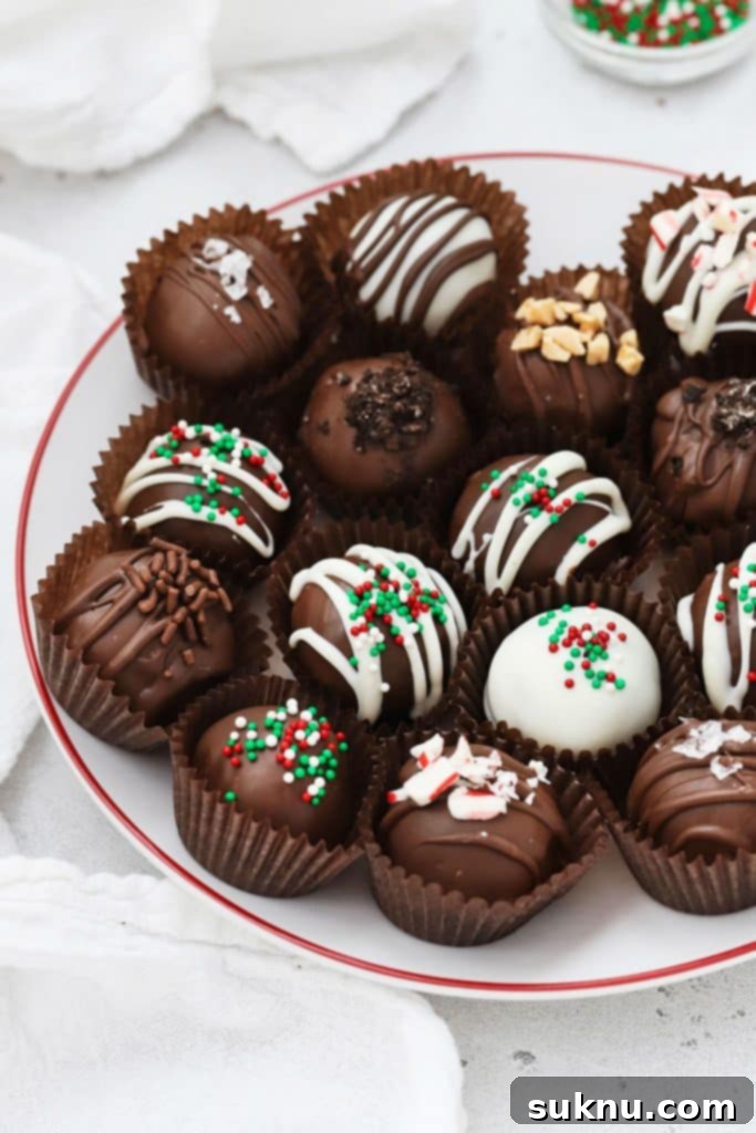 Various gluten-free Oreo truffles adorned with different toppings on a white plate with a red rim