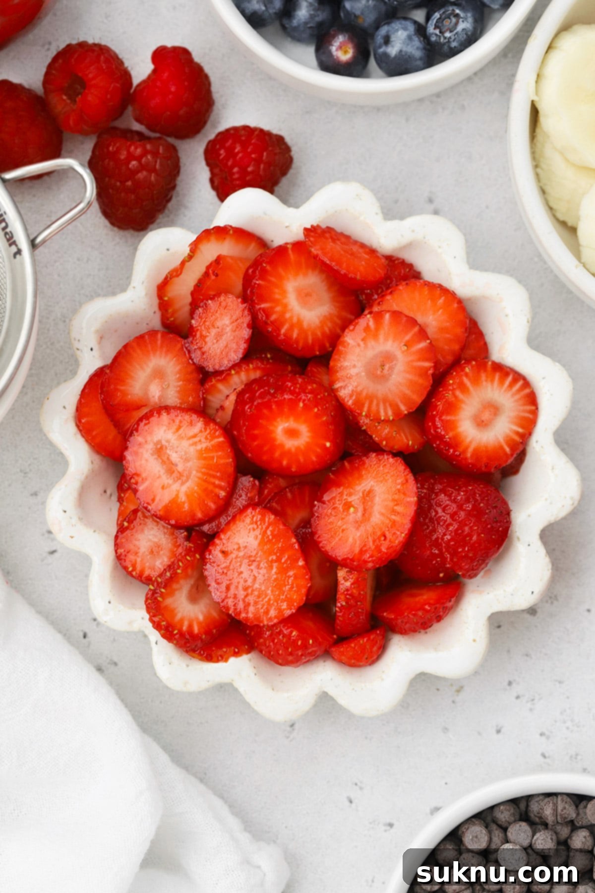A vibrant selection of fresh toppings for gluten-free waffles, including berries, whipped cream, and syrups