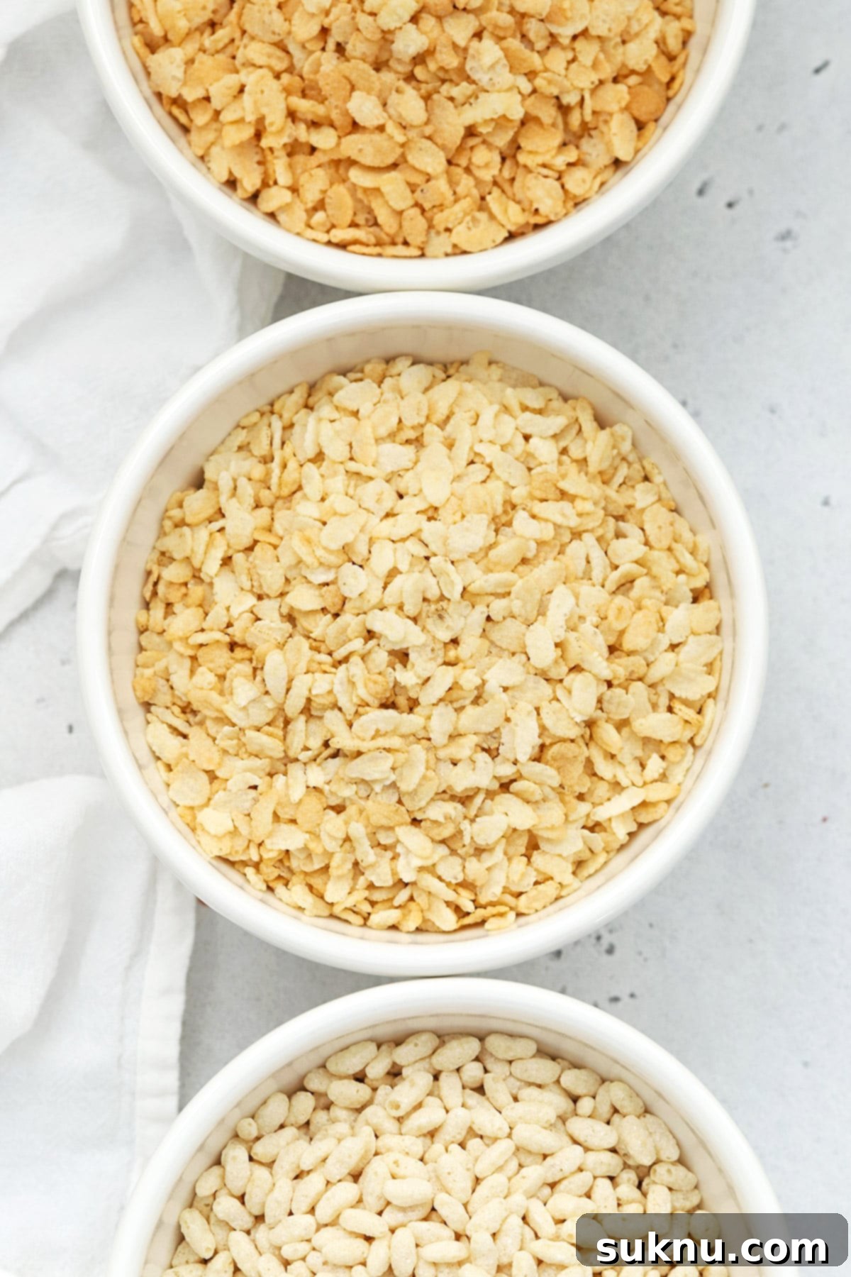 Overhead view of three bowls of gluten-free rice krispies cereals
