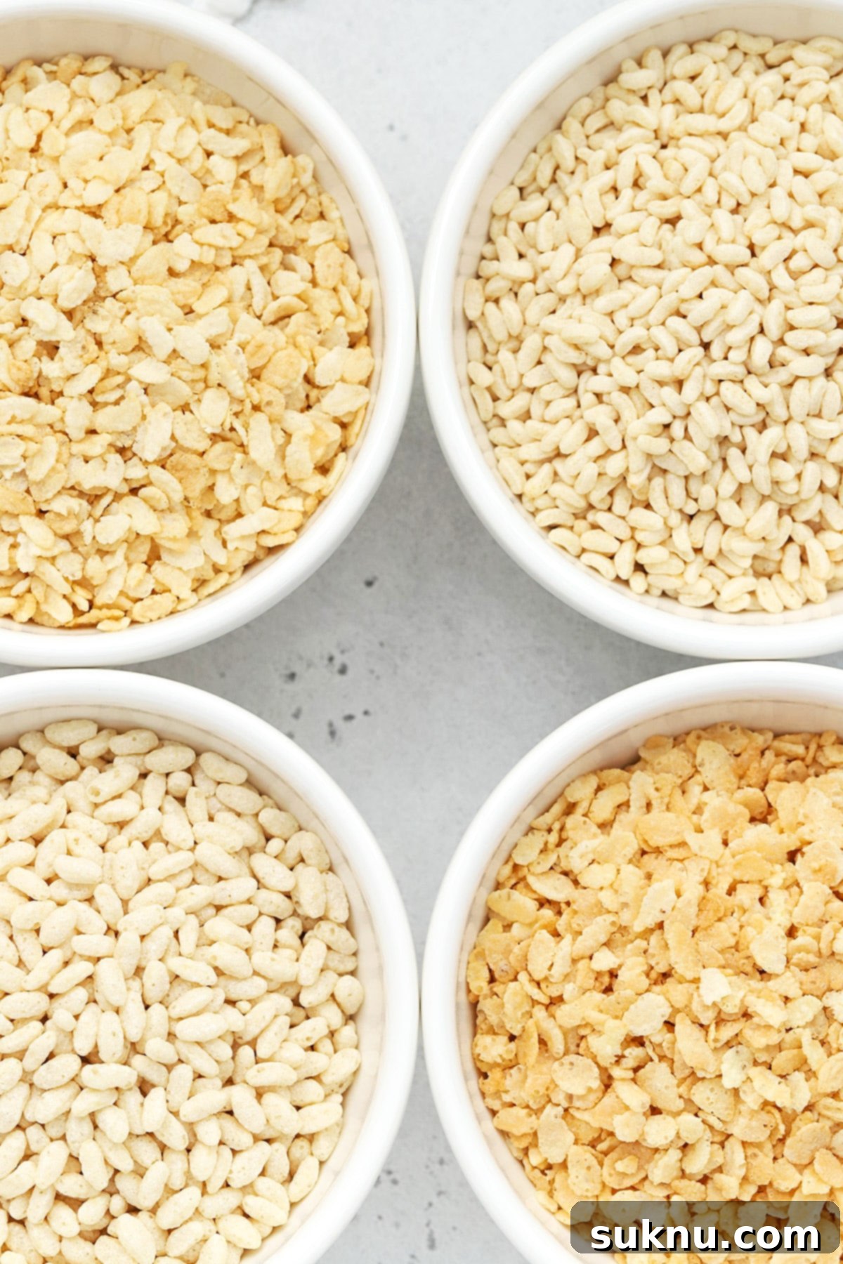 Overhead view of four bowls of gluten-free crisp rice cereals