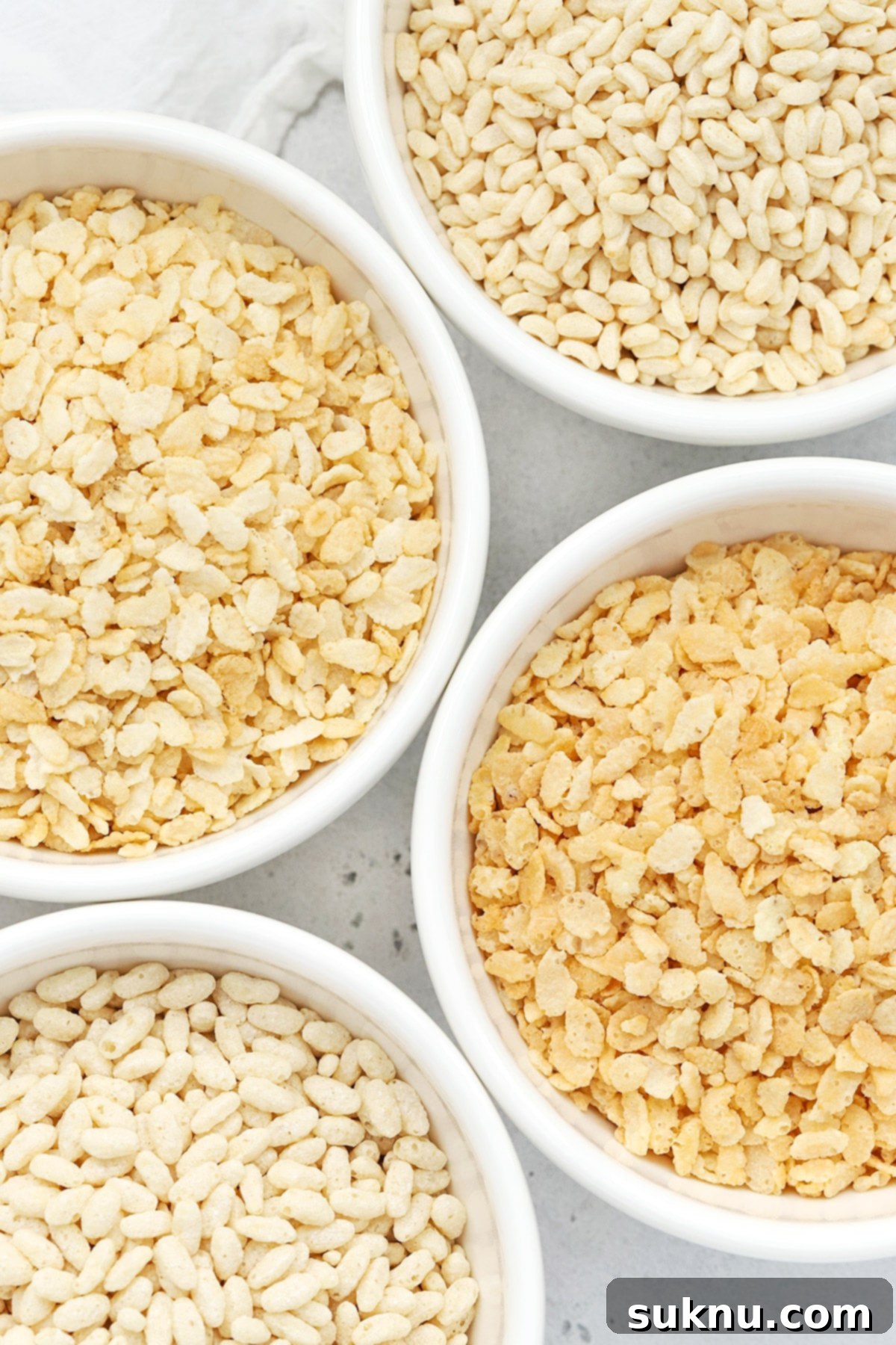 Overhead view of four bowls of gluten-free crisp rice cereals