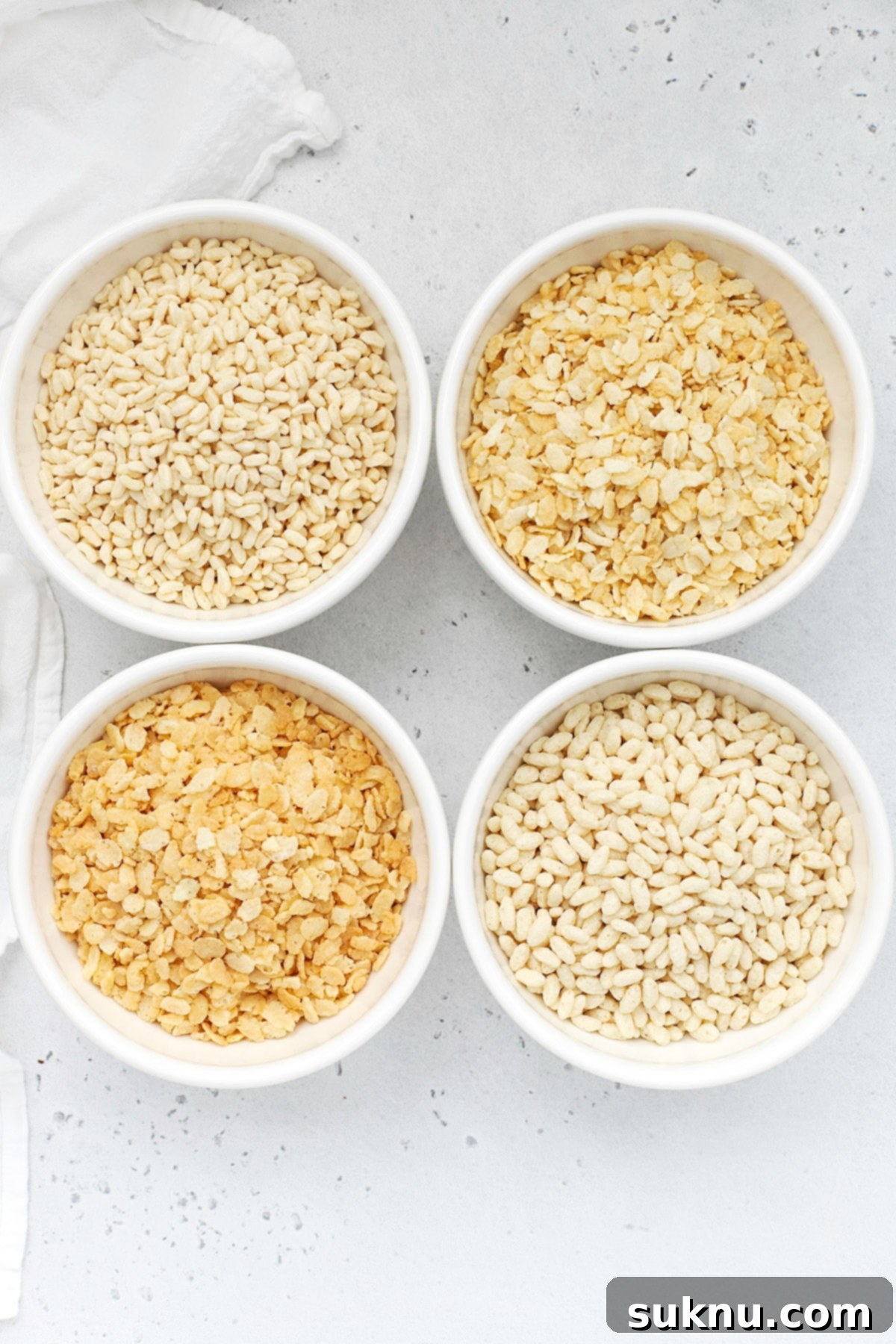 Overhead view of four bowls of gluten-free crisp rice cereals