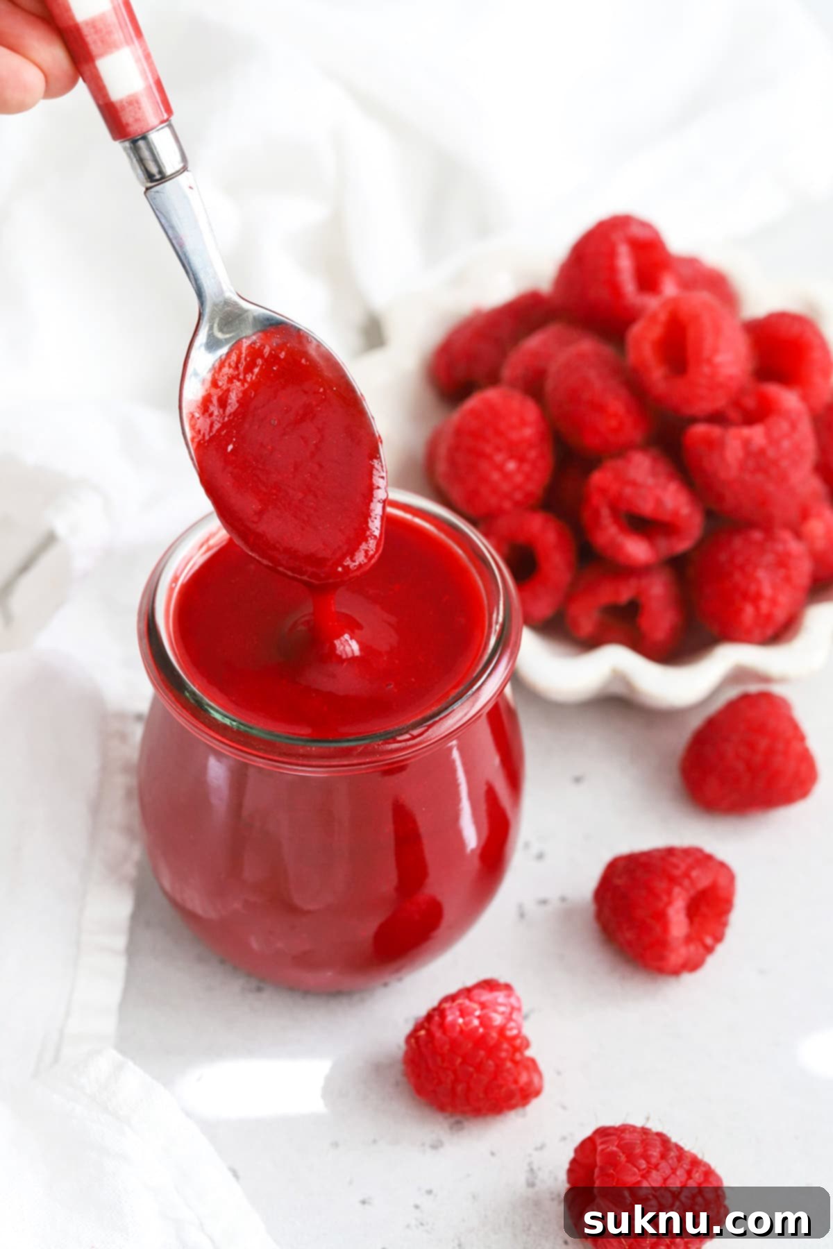 Vibrant Raspberry Coulis 6 Front view of fresh raspberry sauce in a jar