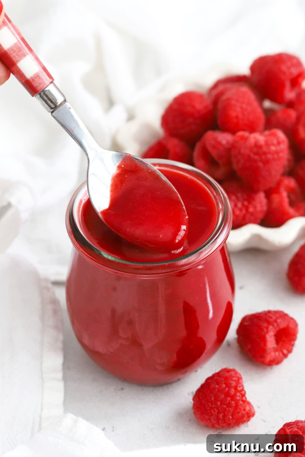 Vibrant Raspberry Coulis 7 Front view of fresh raspberry coulis in a jar