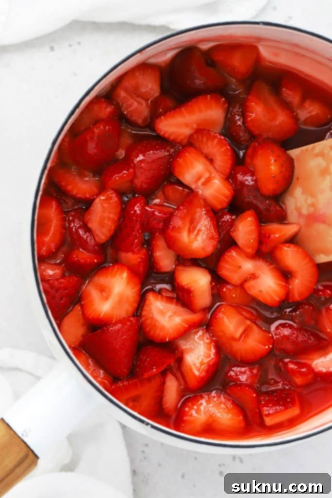 Vibrant Raspberry Coulis 8 thick strawberry sauce in a white saucepan
