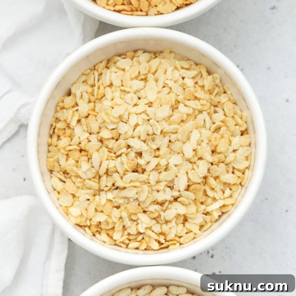 Overhead view of four bowls of different gluten-free crisp rice cereals, emphasizing variety.