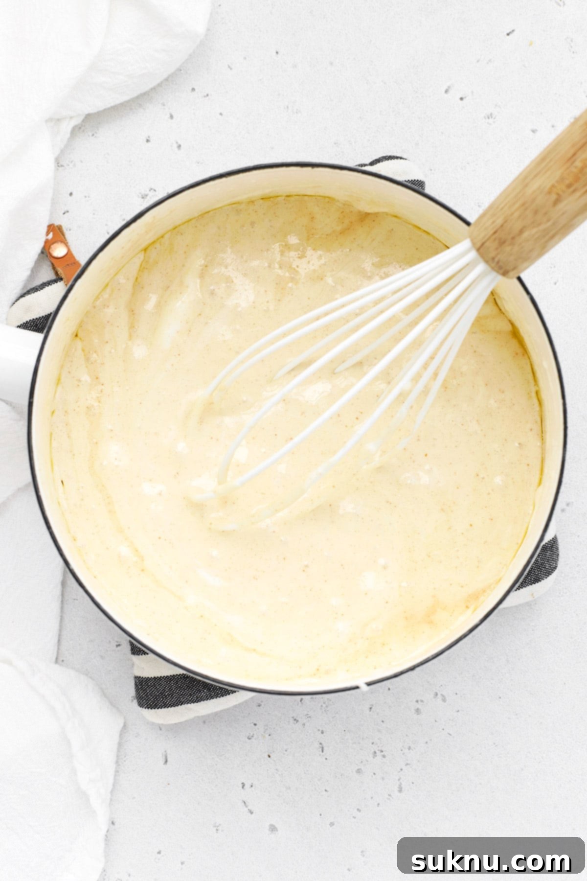 Close-up of mini marshmallows melting into the brown butter, creating a luscious, gooey base for the treats.