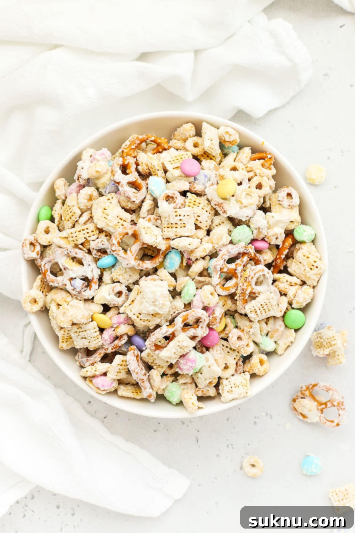 Gluten-Free Easter Bunny Bait Chex Mix 12 Large bowl of bunny bait easter chex mix with pastel m&ms, gluten-free pretzels, and Chex cereal