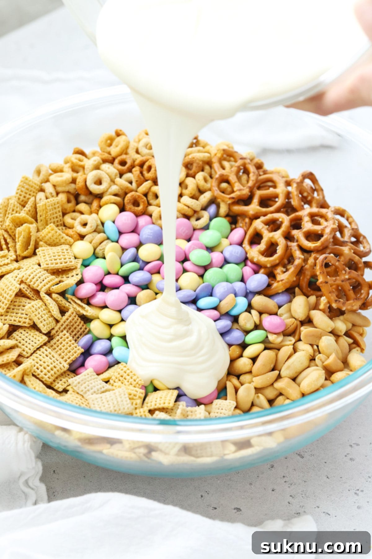 Gluten-Free Easter Bunny Bait Chex Mix 8 Mixing white chocolate into gluten-free bunny bait chex mix