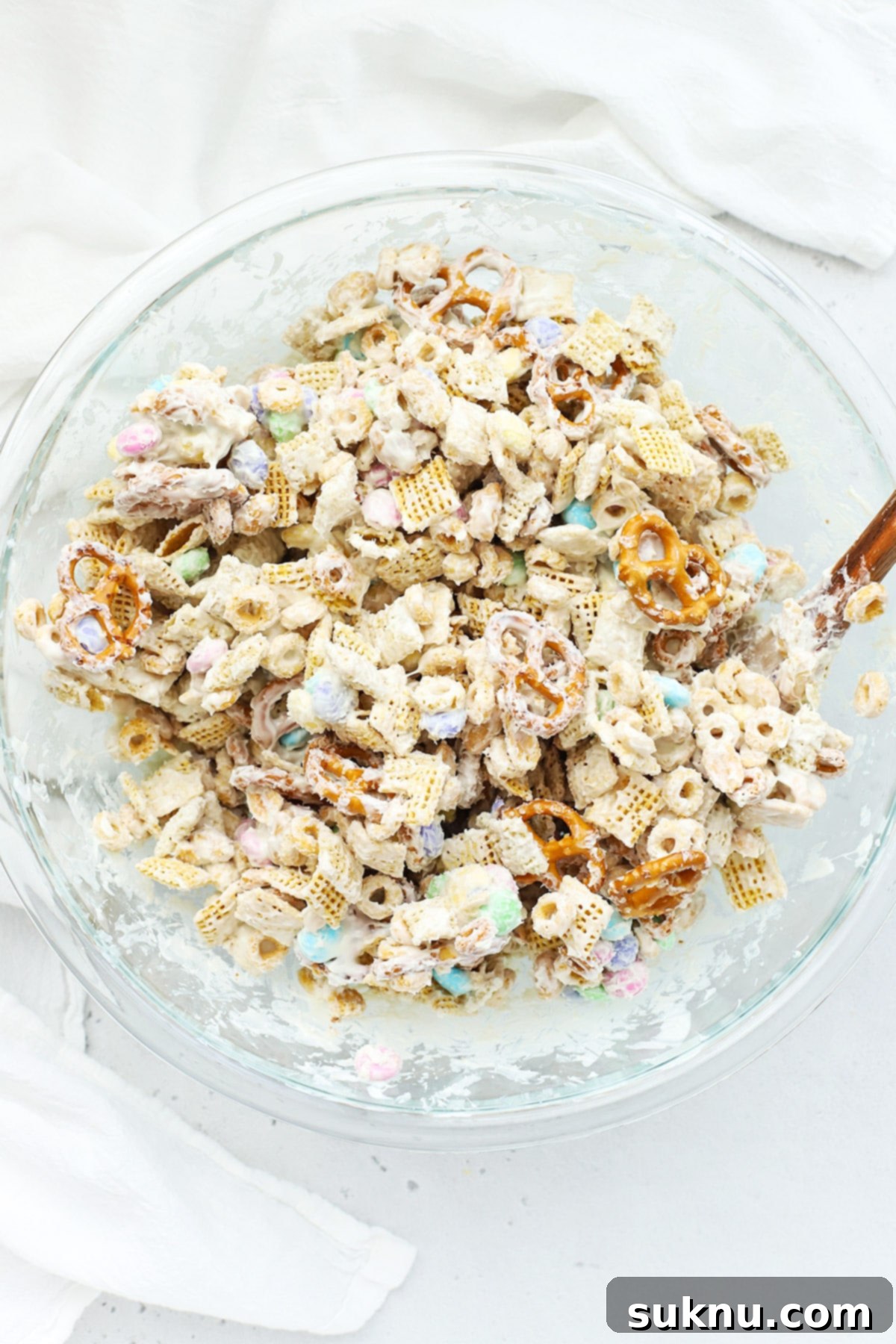 Gluten-Free Easter Bunny Bait Chex Mix 9 Mixing white chocolate into gluten-free bunny bait chex mix
