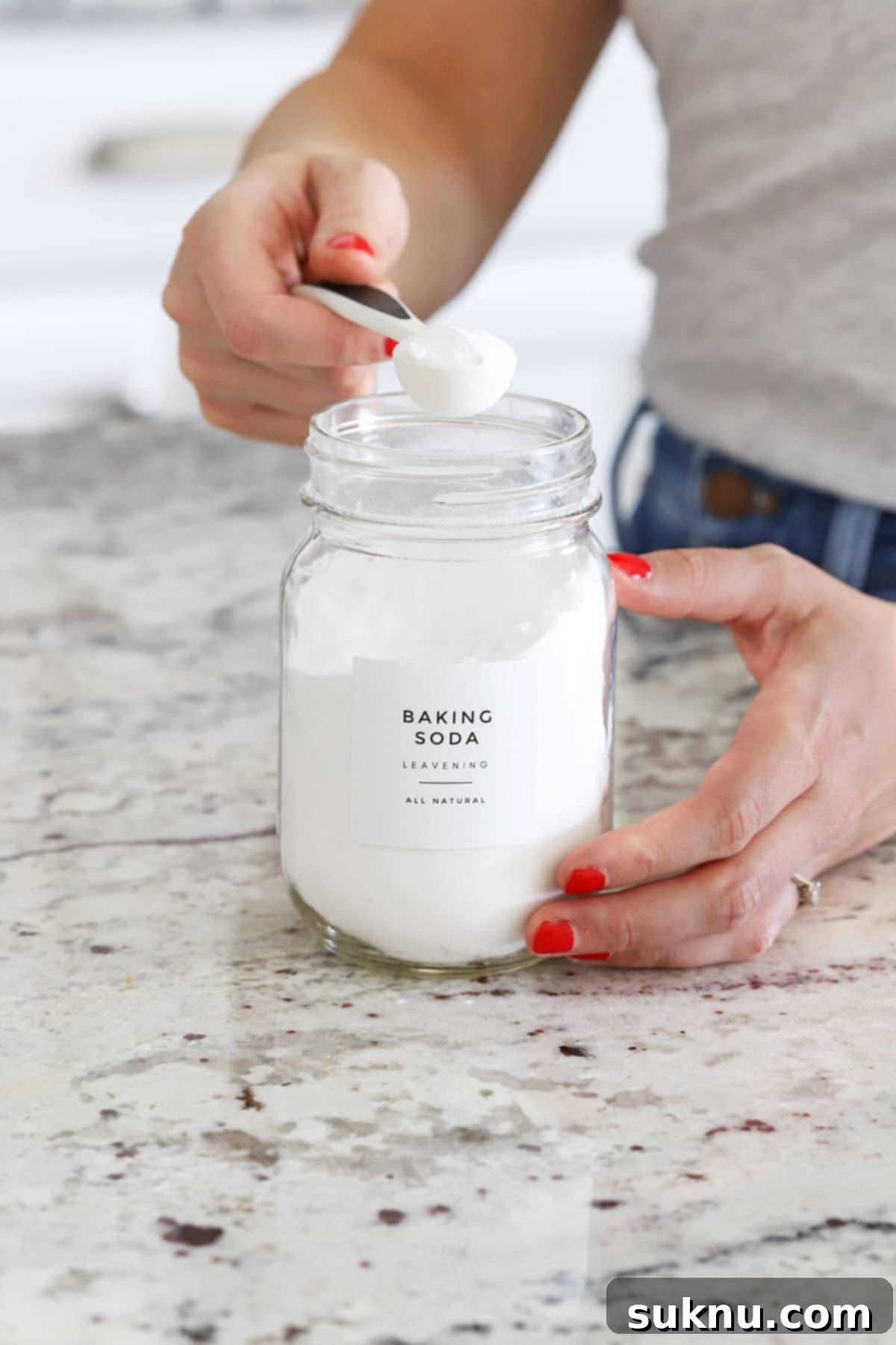 Are Your Baking Powder and Soda Still Potent 5 Hand scooping fresh baking soda from a container, ready for the freshness test.