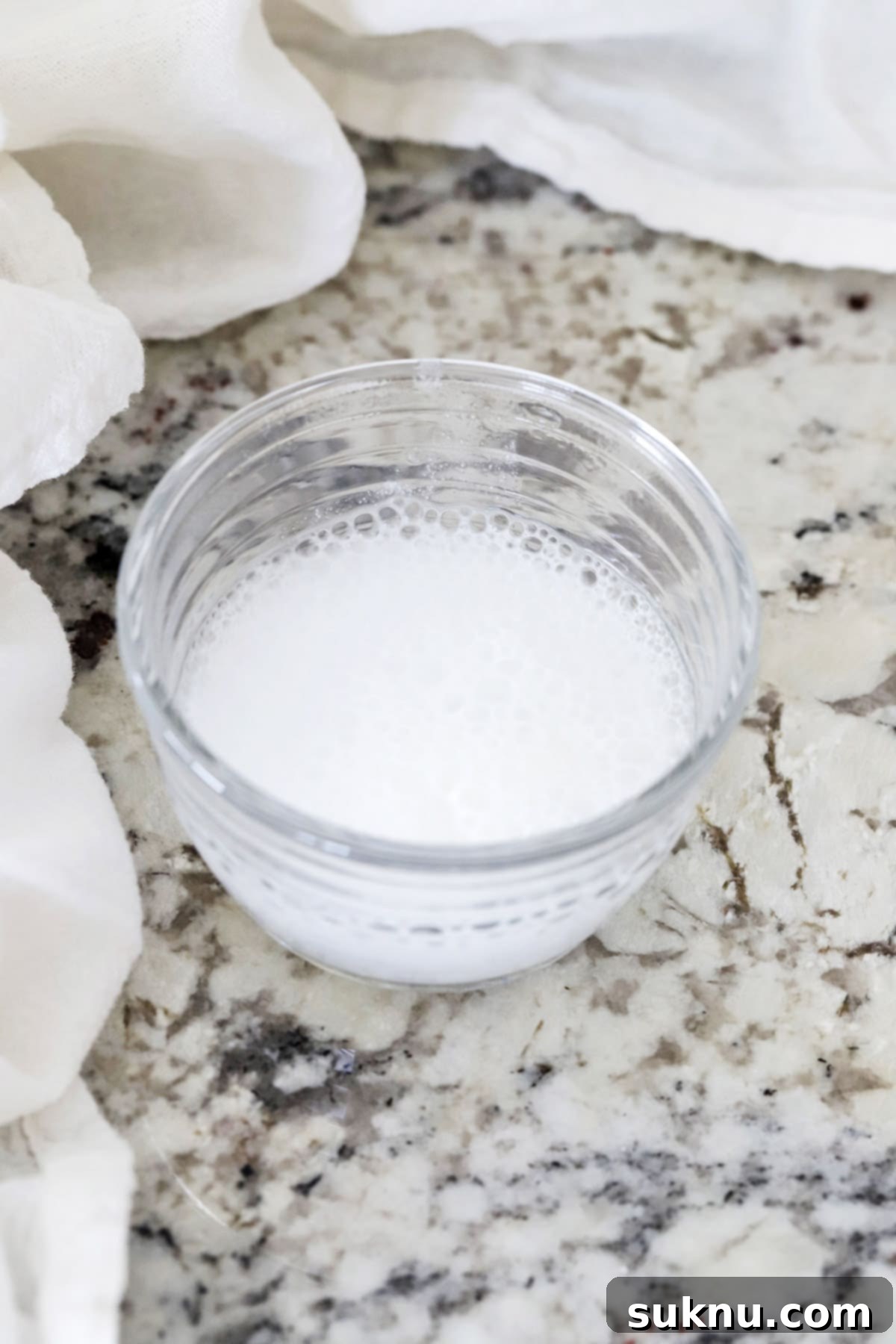 Are Your Baking Powder and Soda Still Potent 6 A small bowl showing vigorous fizzing after baking soda is added to vinegar, indicating it's fresh and active for baking.