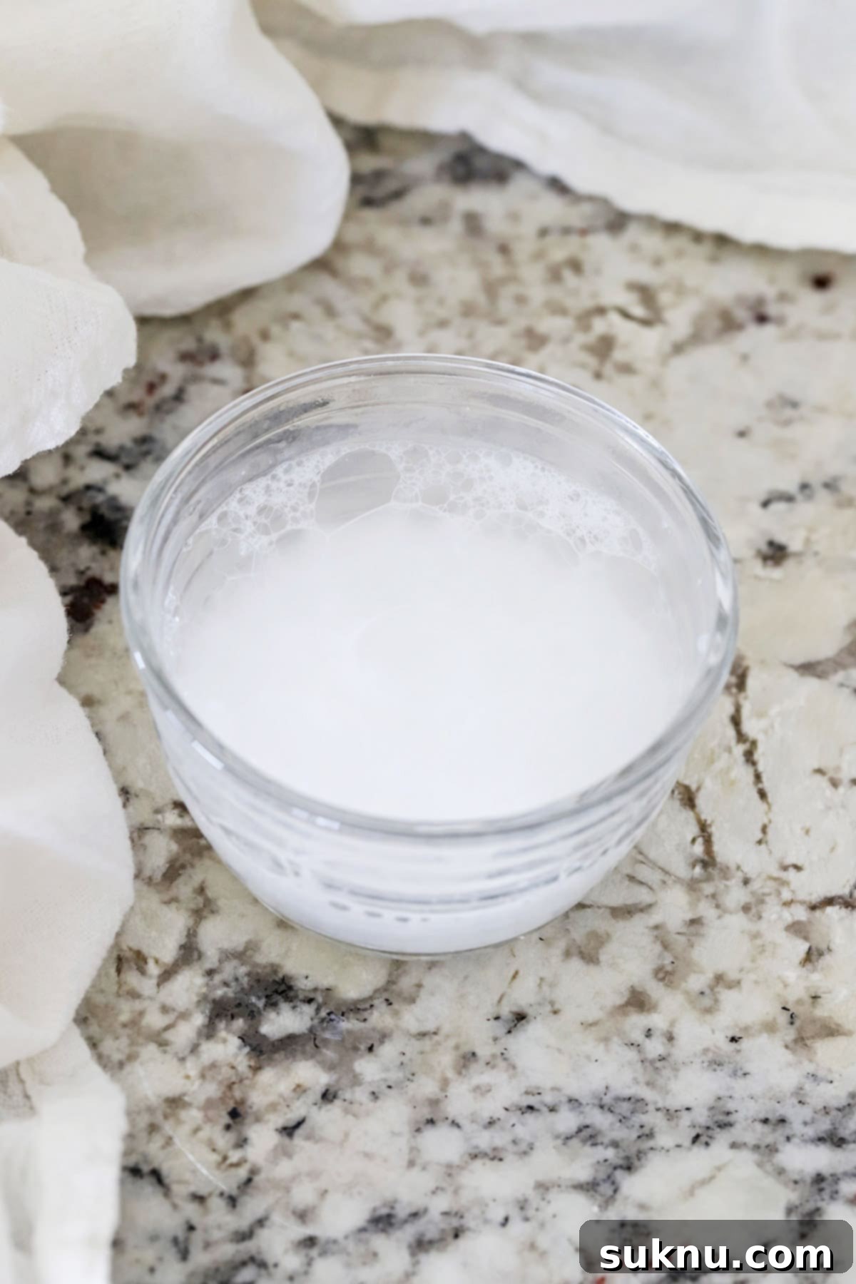 Are Your Baking Powder and Soda Still Potent 8 A small bowl showing active fizzing after baking powder is added to warm water, confirming its freshness.