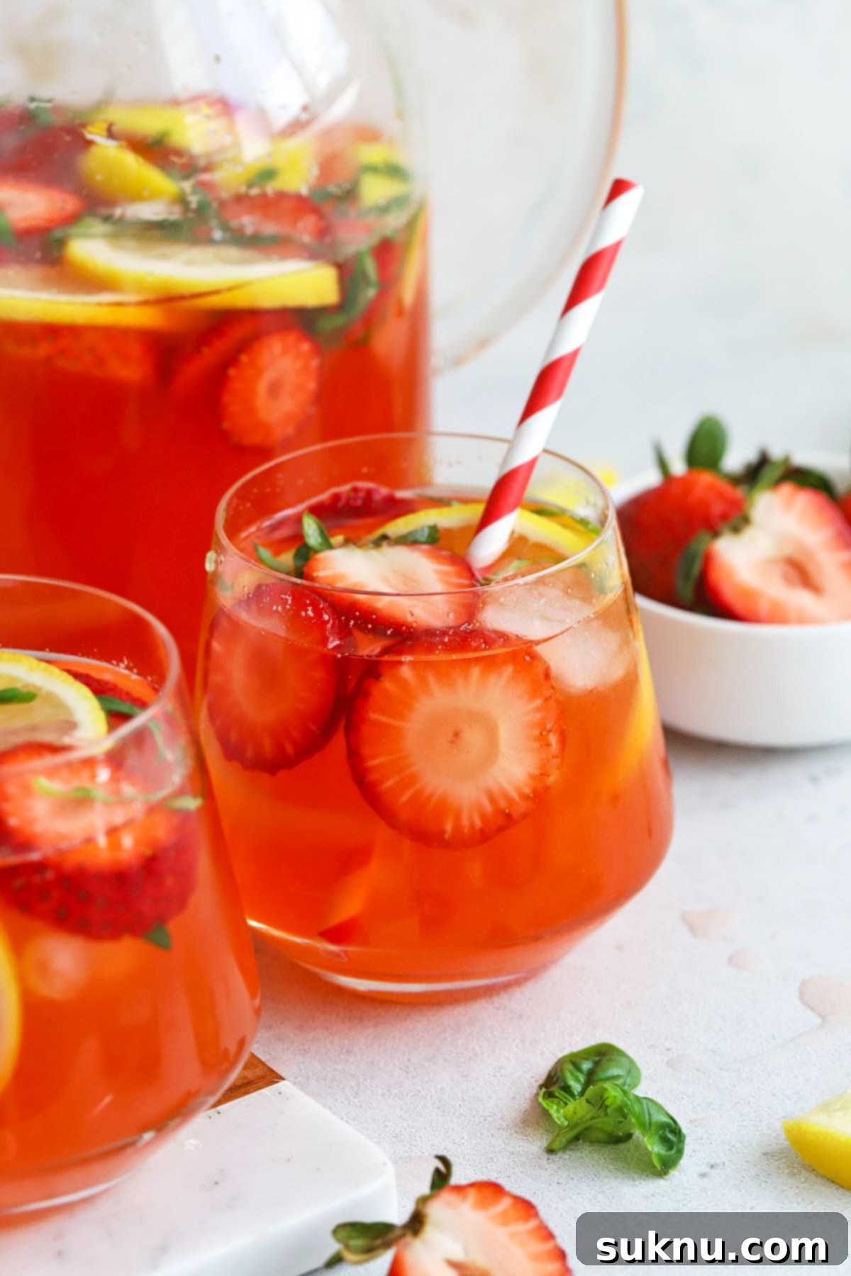 Strawberry Basil Bliss Lemonade 2 A refreshing glass of homemade strawberry basil lemonade, garnished with fresh basil and lemon slices, ready for a warm summer day.