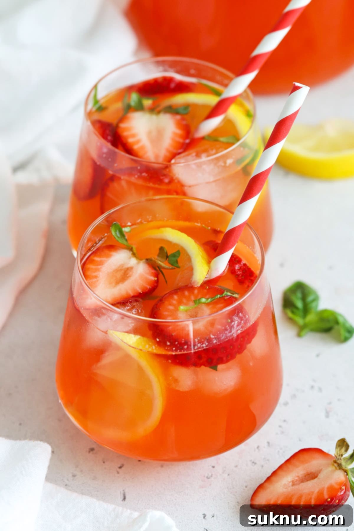 Strawberry Basil Bliss Lemonade 6 A close-up of a glass of strawberry basil lemonade, highlighting the vibrant color and fresh ingredients.