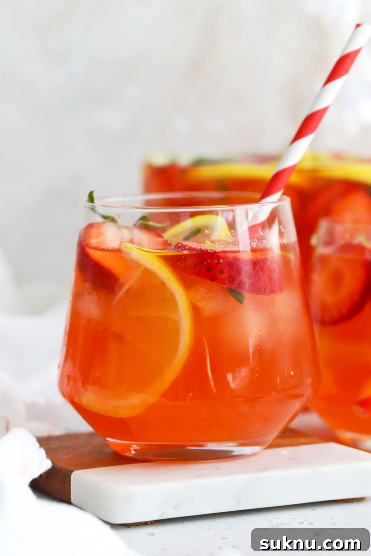 Strawberry Basil Bliss Lemonade 7 A beautifully presented glass of homemade strawberry basil lemonade, garnished with fresh strawberries and basil.
