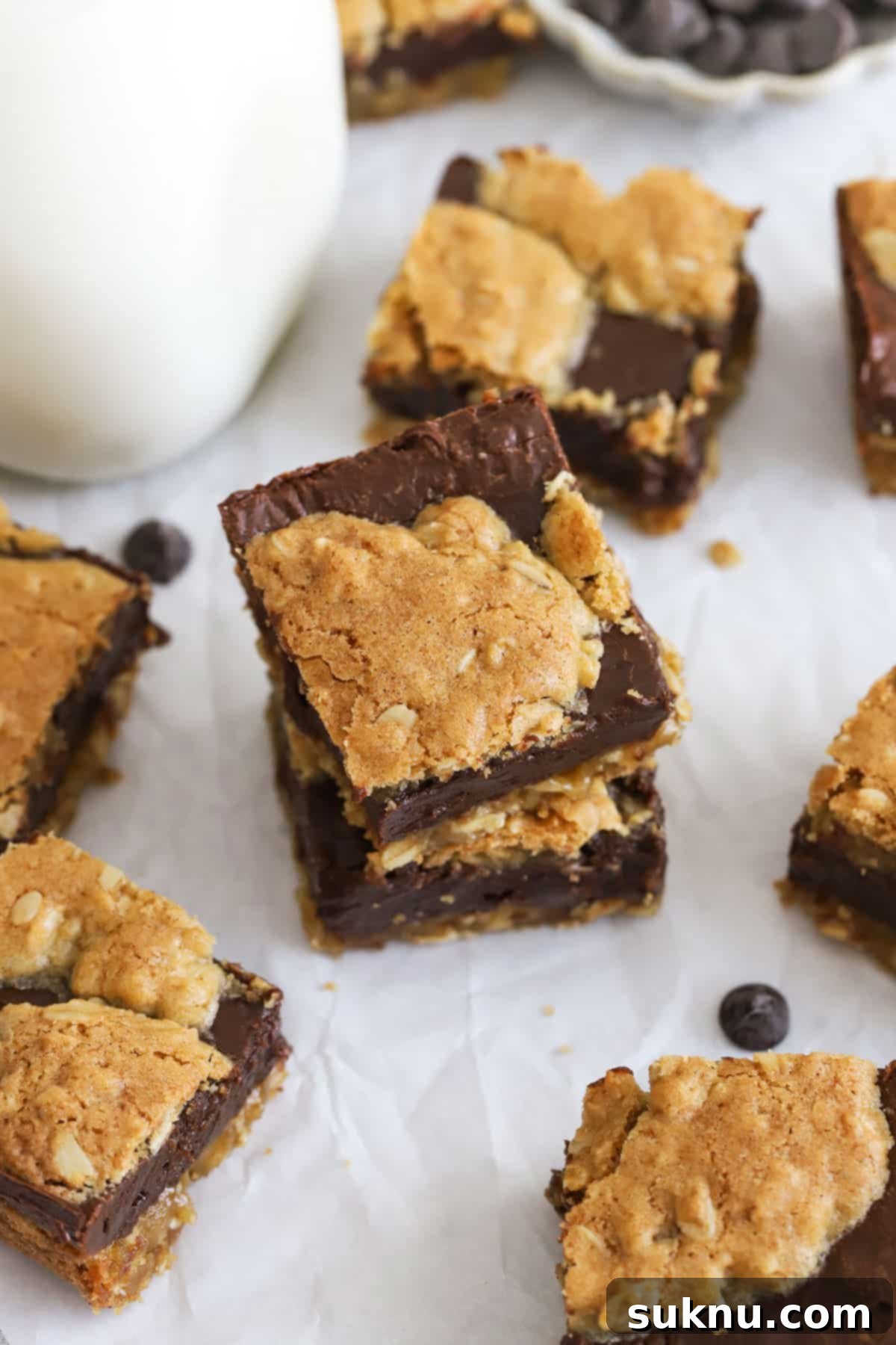 Decadent Gluten-Free Oatmeal Fudge Bars 6 Gluten-free oatmeal fudge bars stacked neatly near a bottle of milk