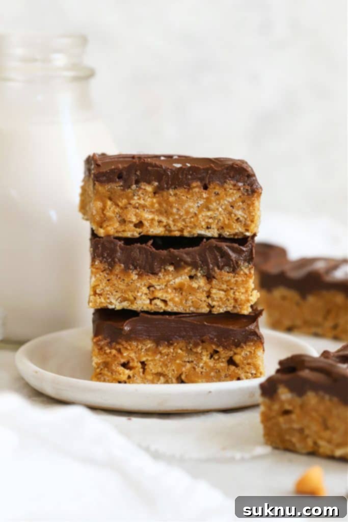 Decadent Gluten-Free Oatmeal Fudge Bars 9 Three gluten-free scotcheroo squares stacked on a white dessert plate