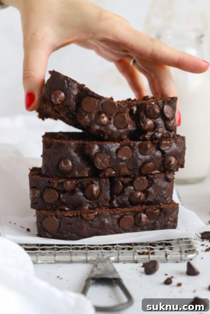 Decadent Gluten-Free Chocolate Banana Bread 13 Front view of a tempting stack of moist, gluten-free chocolate banana bread slices, revealing the perfectly baked texture and generous distribution of chocolate chips within.