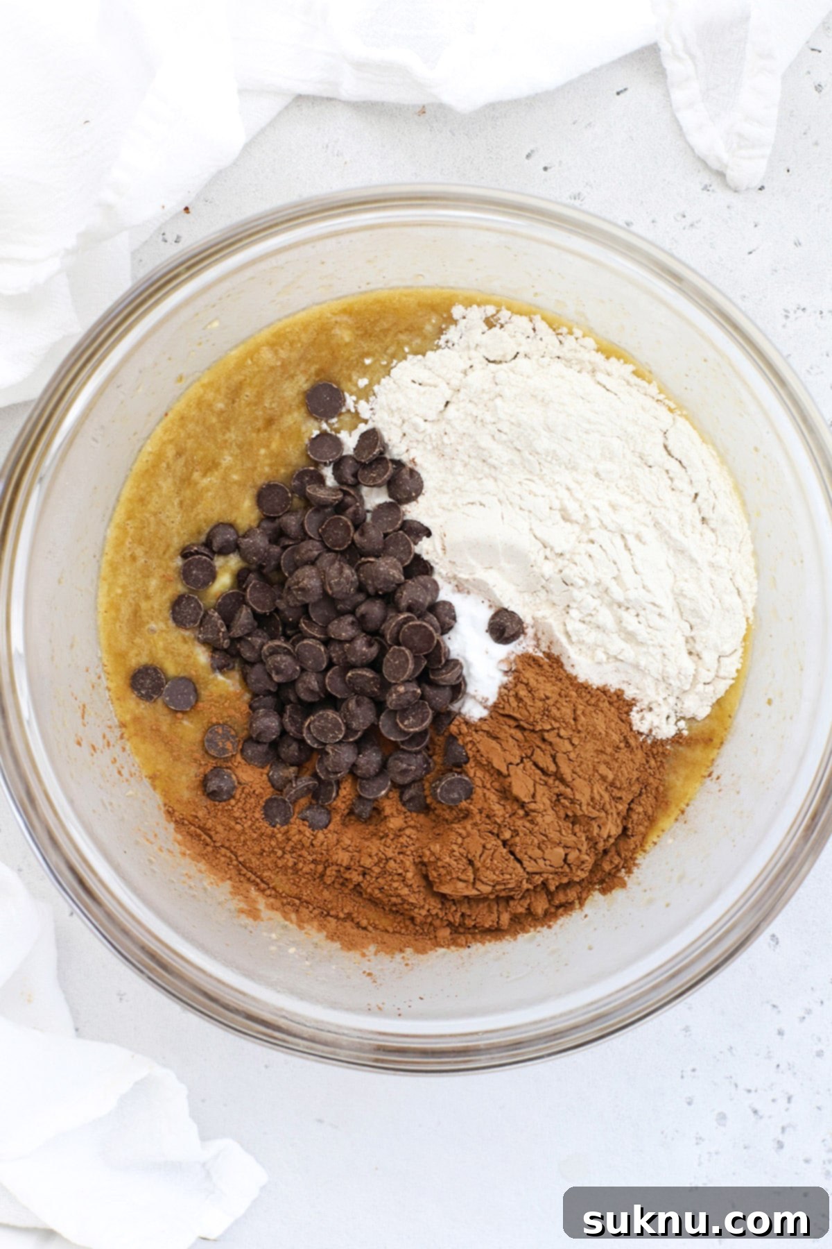 Decadent Gluten-Free Chocolate Banana Bread 7 The moment dry ingredients, including gluten-free flour, cocoa powder, baking soda, and salt, are gently folded into the wet mixture, gradually transforming into a luscious chocolate banana bread batter.