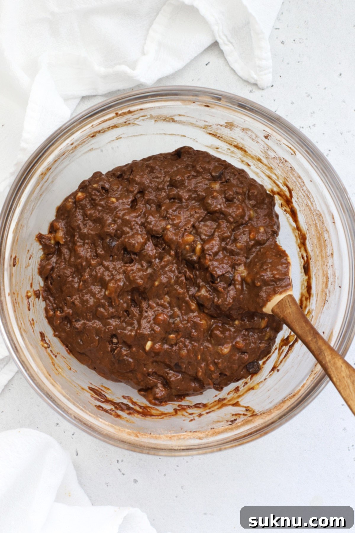 Decadent Gluten-Free Chocolate Banana Bread 8 A large mixing bowl brimming with freshly prepared gluten-free chocolate banana bread batter, rich in color and generously studded with chocolate chips, poised for transfer to the baking pan.