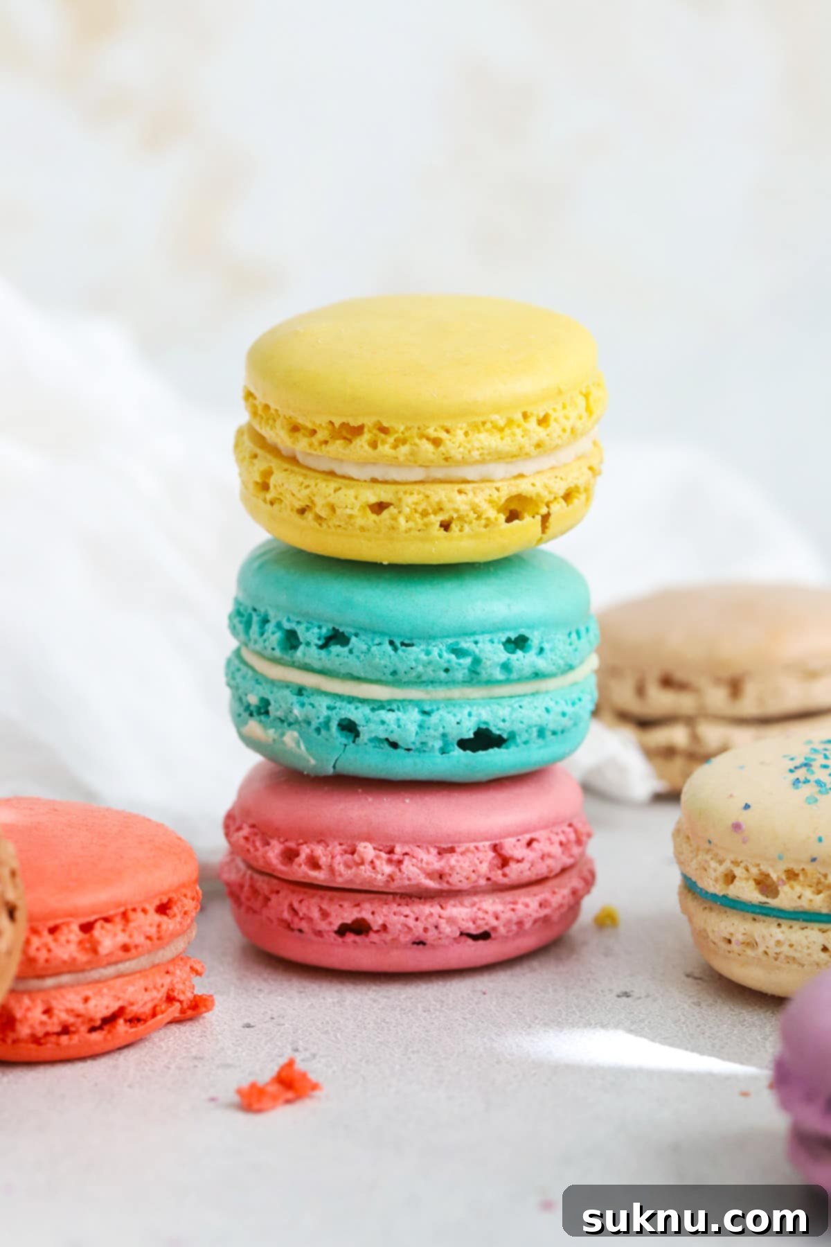 Unlock Room Temperature Eggs in Minutes 4 Colorful macarons stacked in a tower, a delicate dessert that benefits from room temperature eggs.
