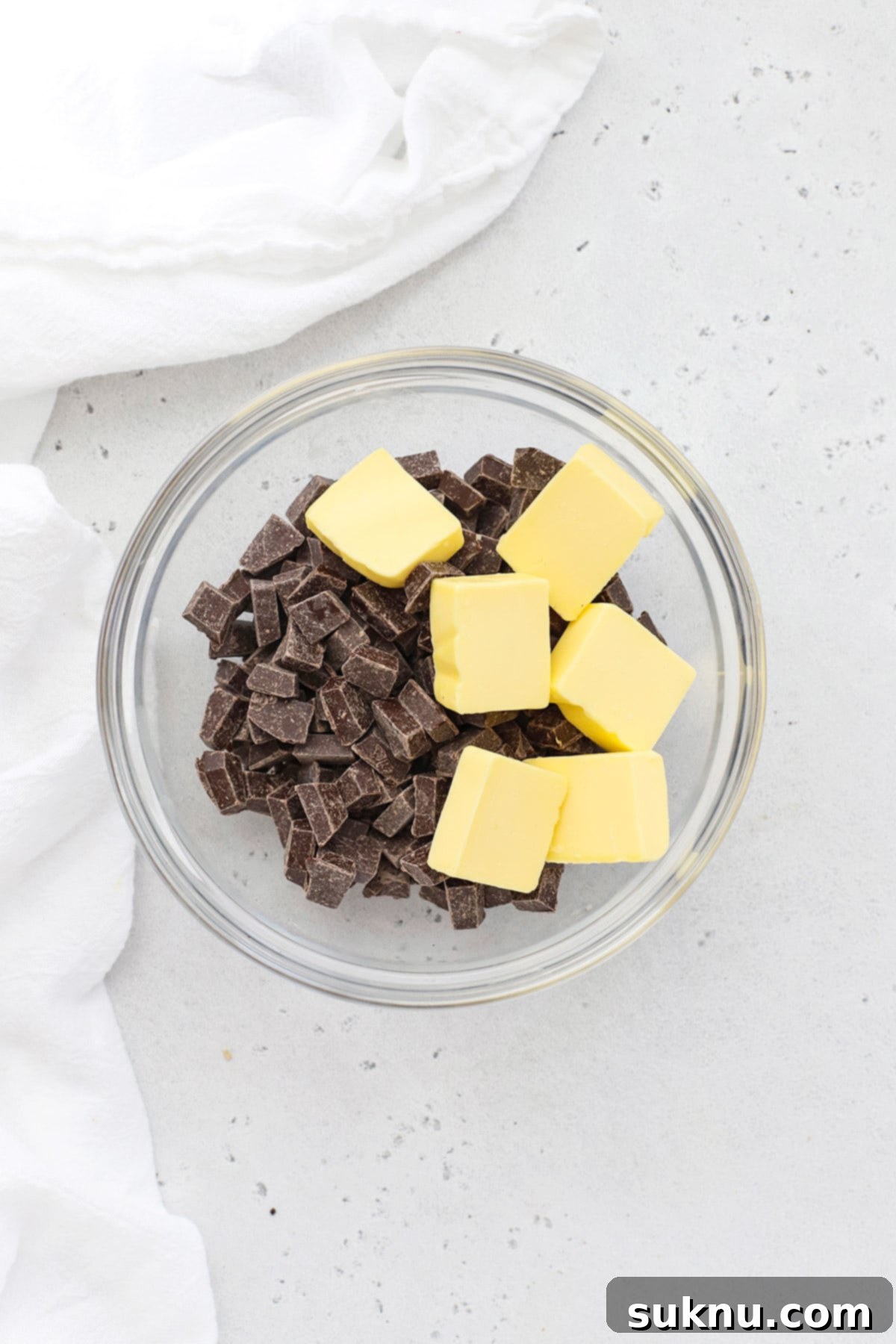 Melting chocolate and butter in a bowl for gluten-free brownie cookies.