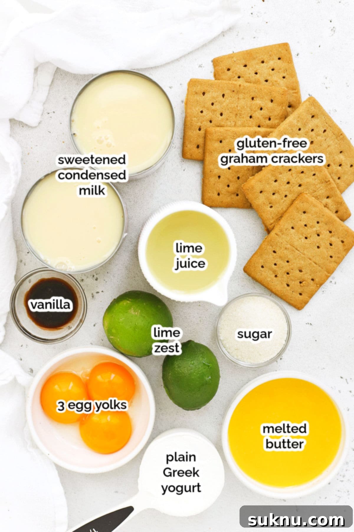 Ingredients for gluten-free key lime pie bars, including limes, condensed milk, and graham crackers