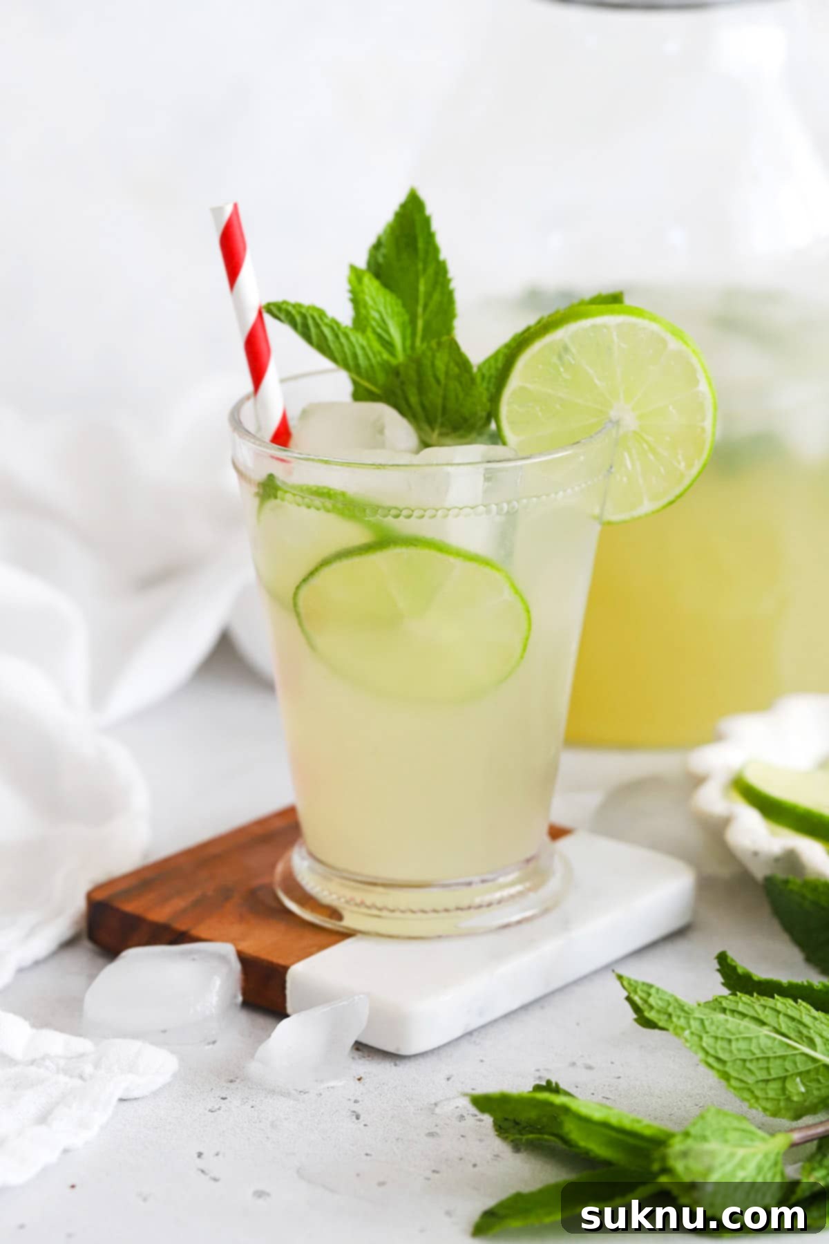 Zesty Mint Lime Mocktail 12 Two elegantly presented glasses of virgin mojito mint limeade, garnished with fresh mint and lime, ready to be enjoyed.