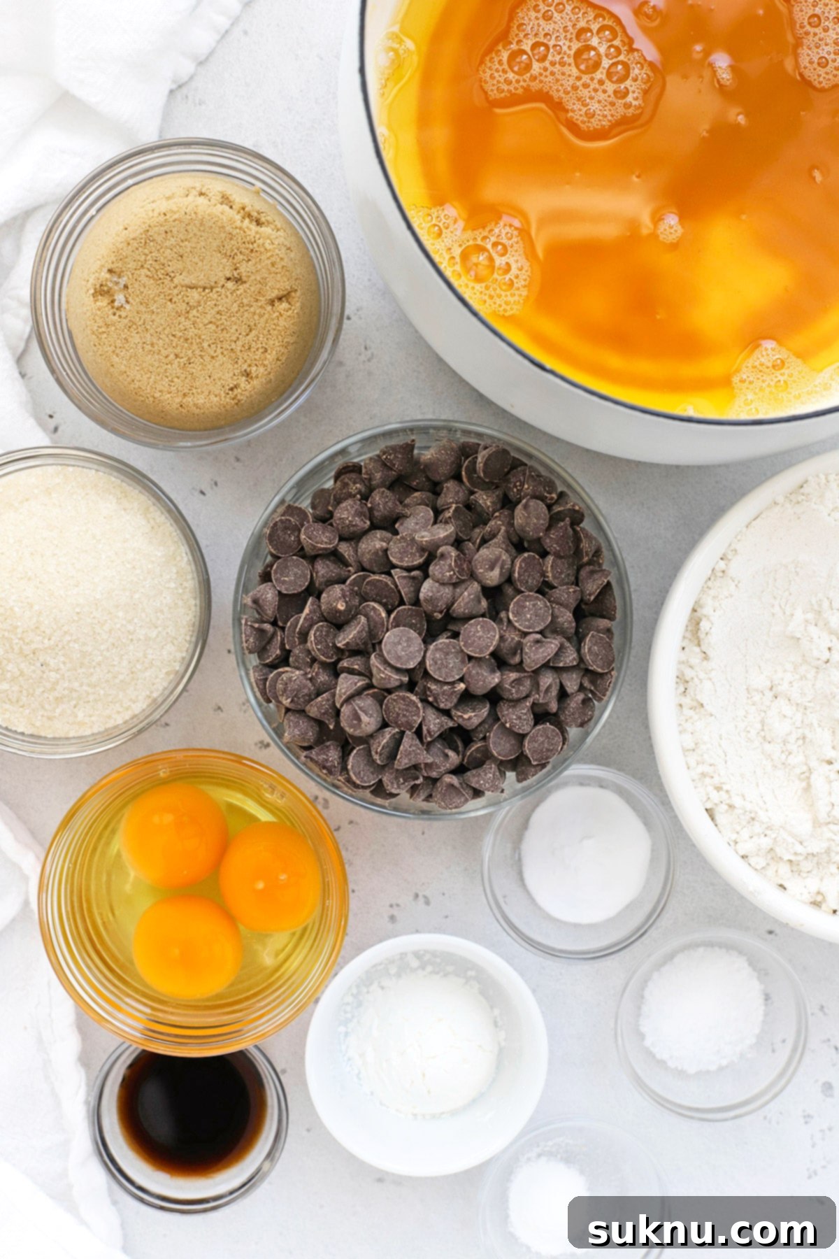 An overhead view of all the simple, high-quality ingredients laid out for baking gluten-free Nutella-stuffed chocolate chip cookies.