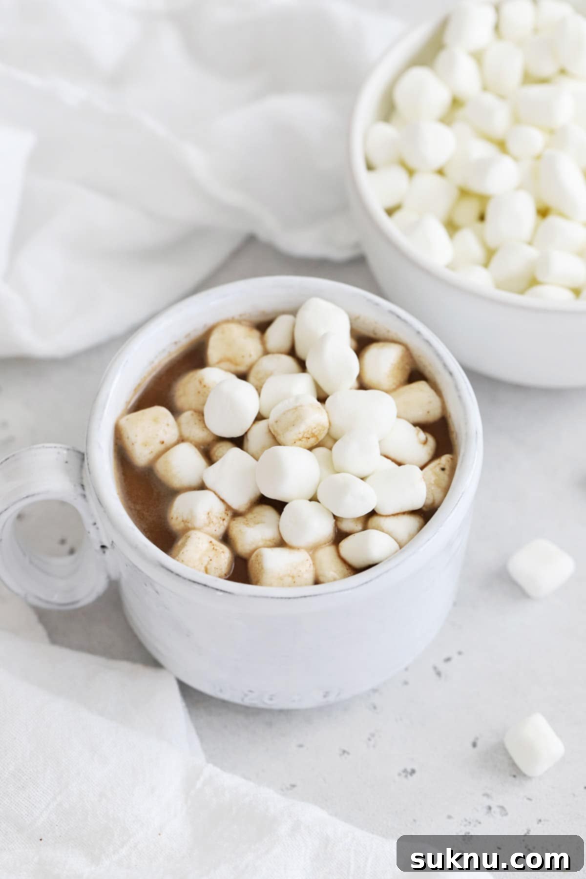 Front view of a mug of hot chocolate topped with mini marshmallows
