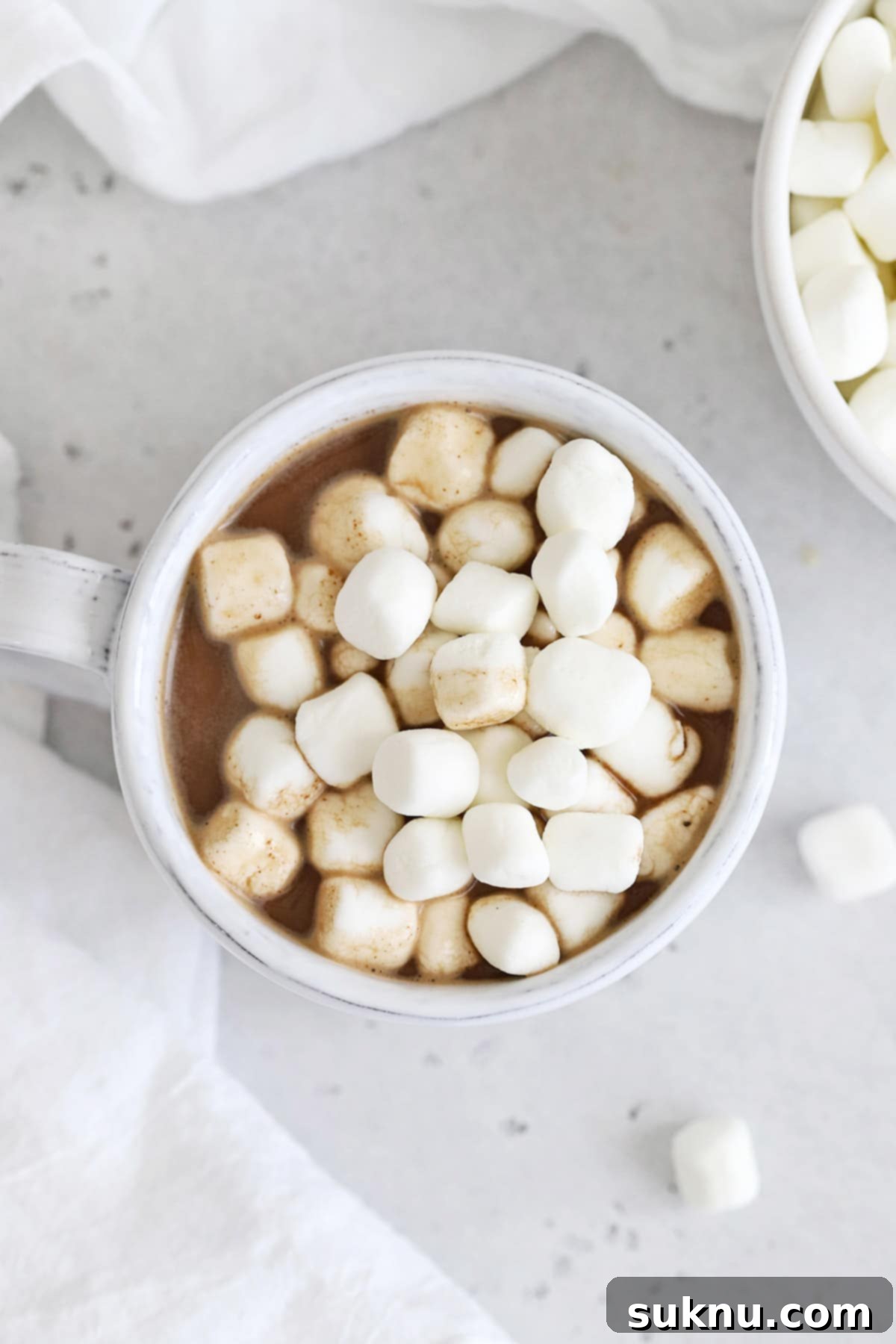Overhead view of a mug of hot chocolate topped with mini marshmallows
