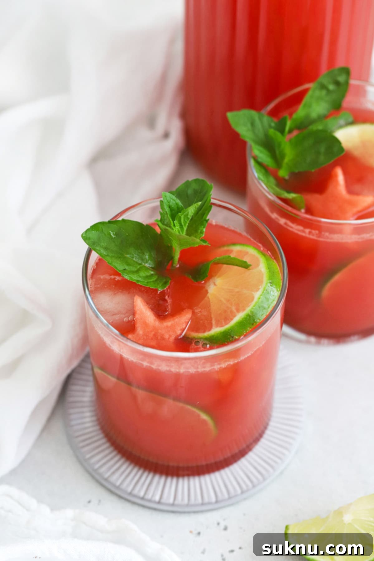 Watermelon Agua Fresca (Agua de Sandia) garnished with watermelon, lime, and mint