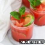 Watermelon Agua Fresca (Agua de Sandia) garnished with watermelon, lime, and mint