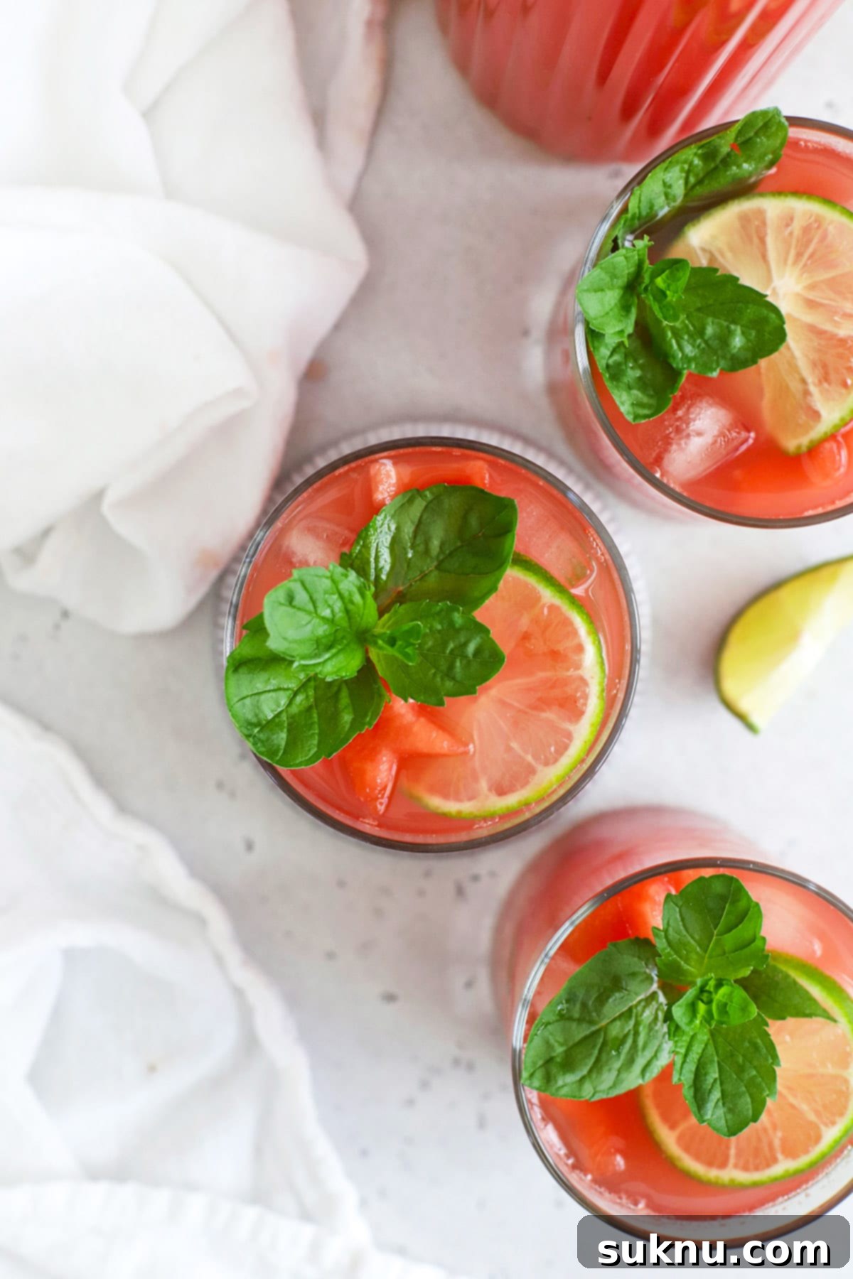 Overhead view of Watermelon Agua Fresca (Agua de Sandia) garnished with watermelon, lime, and mint
