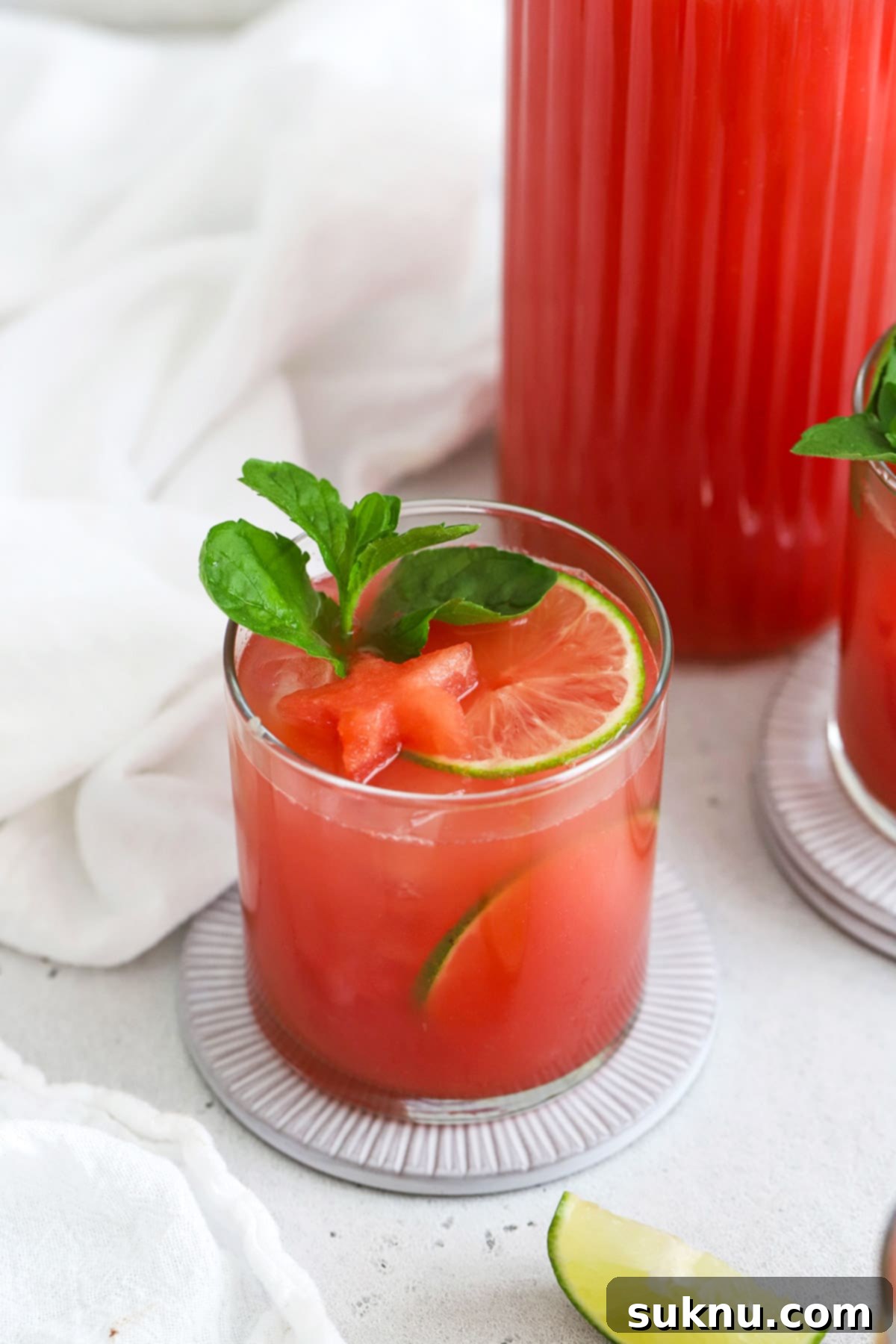 Watermelon Agua Fresca (Agua de Sandia) garnished with watermelon, lime, and mint