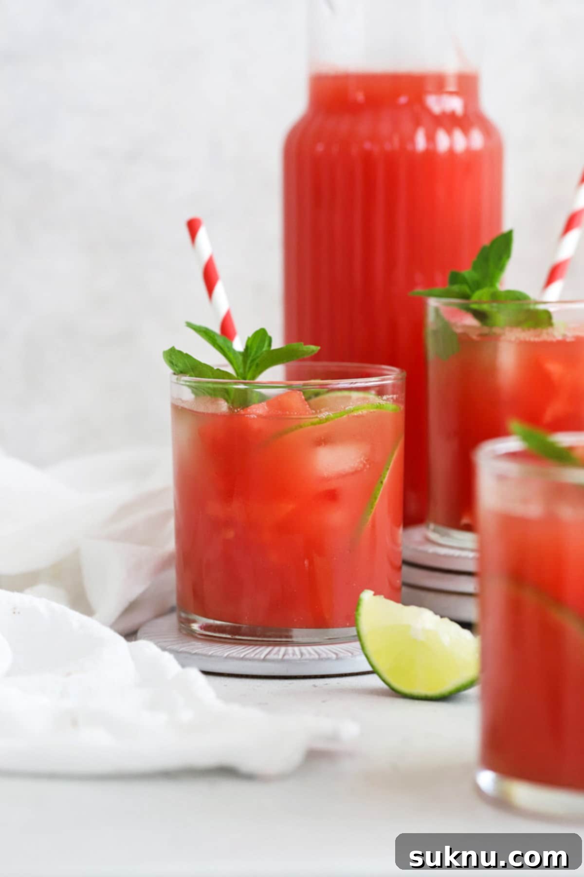 Watermelon Agua Fresca (Agua de Sandia) garnished with watermelon, lime, and mint