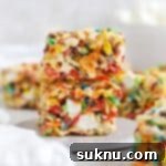 Gluten-Free Fruity Pebbles Treats 10 two fruity pebble rice krispies treats stacked on a white dessert plate