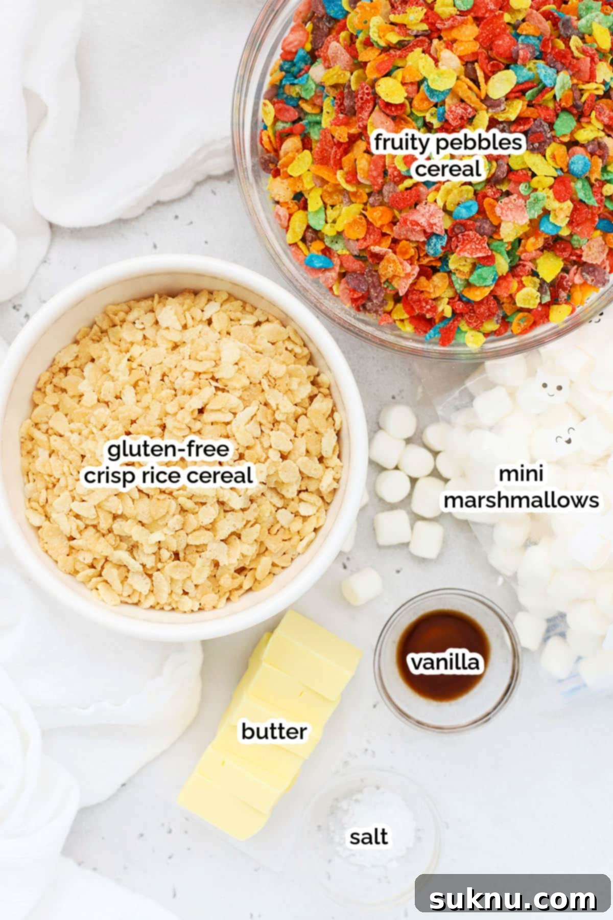 Gluten-Free Fruity Pebbles Treats 3 A vibrant flat lay of ingredients for making gluten-free Fruity Pebbles treats, including colorful cereal, marshmallows, and butter.