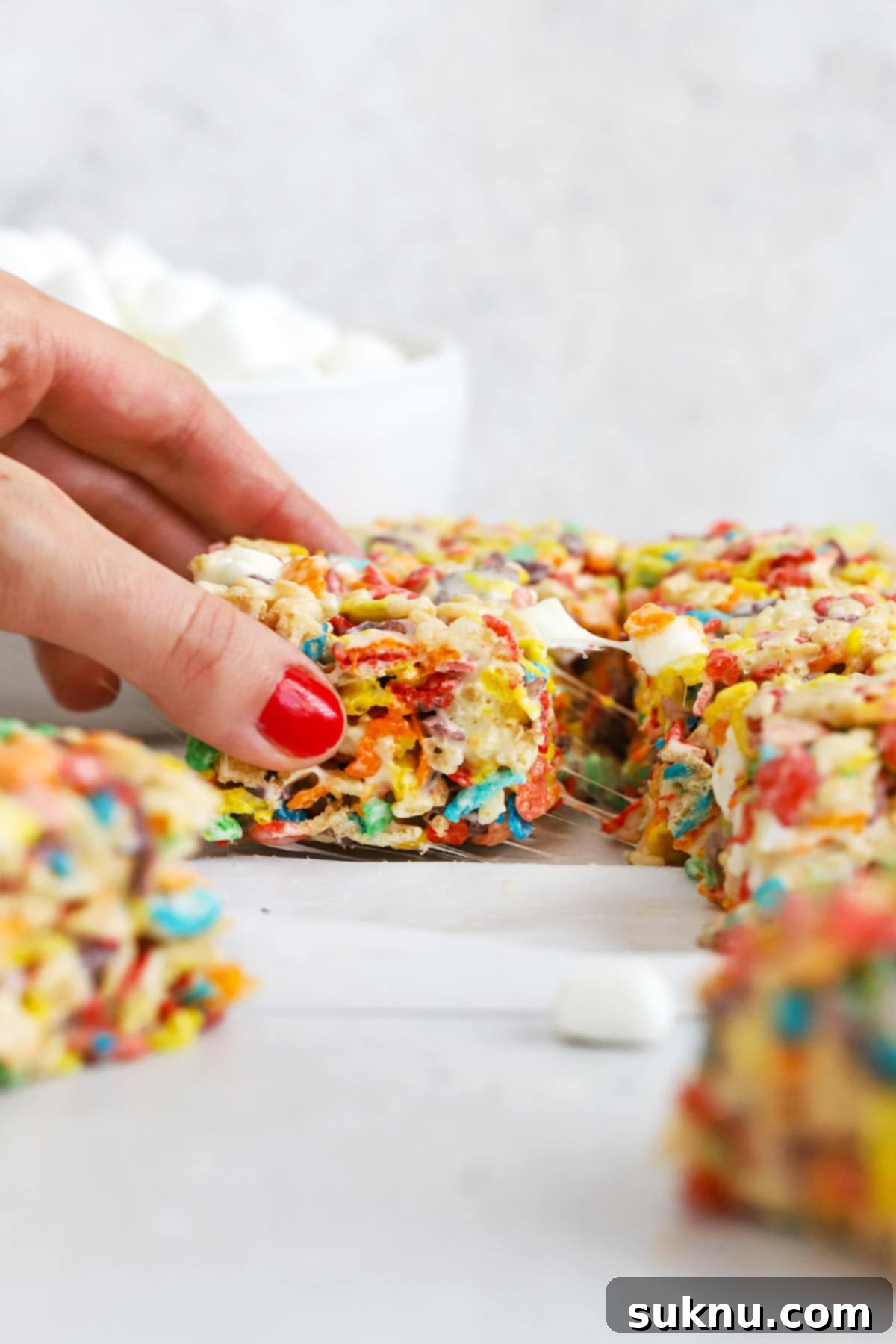 Gluten-Free Fruity Pebbles Treats 6 Close-up front view of neatly cut gluten-free Fruity Pebbles treats, showcasing their texture and vibrant colors.