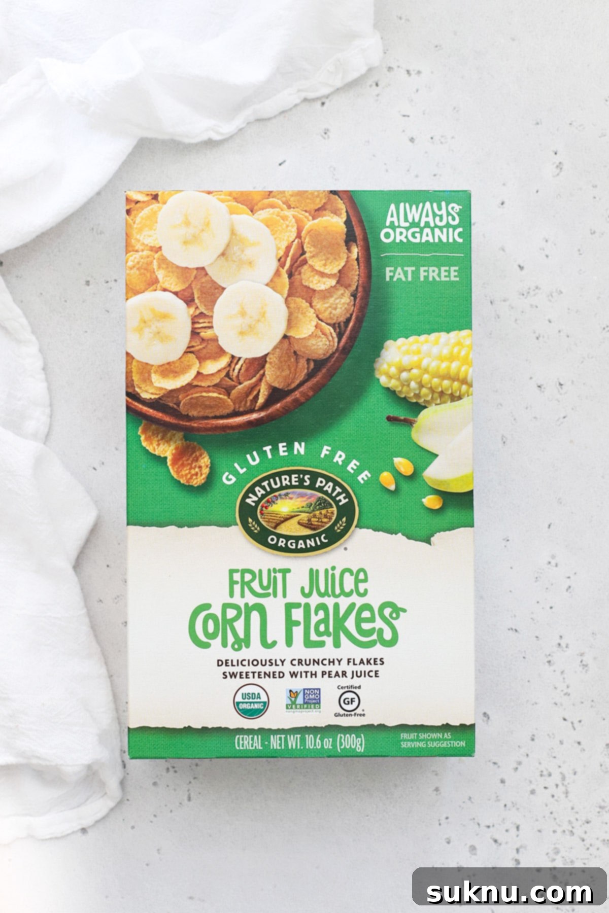 A box of Nature's Path Fruit Juice Sweetened Corn Flakes, highlighting its vegan and naturally sweetened attributes