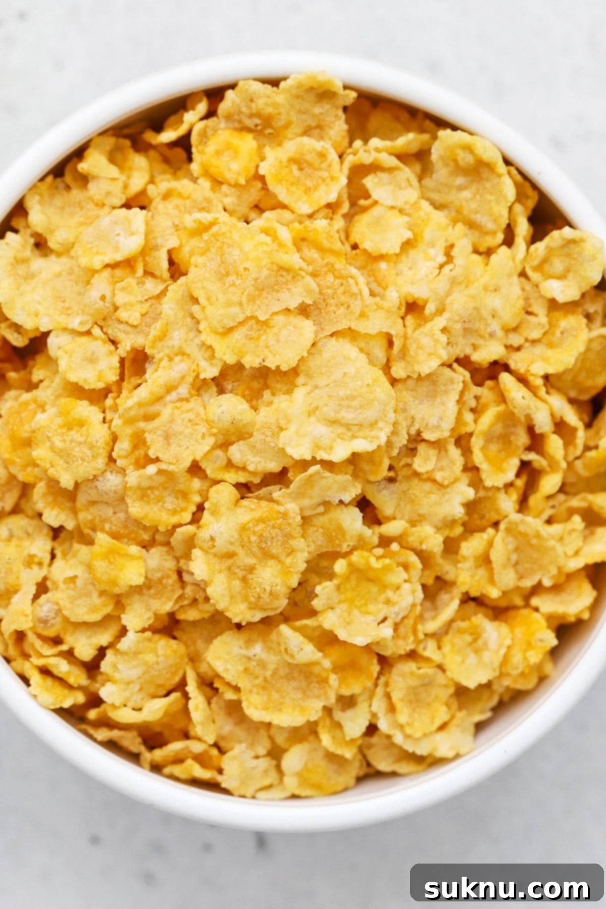 A vibrant bowl of gluten-free corn flakes with fresh berries, showcasing their delicious versatility