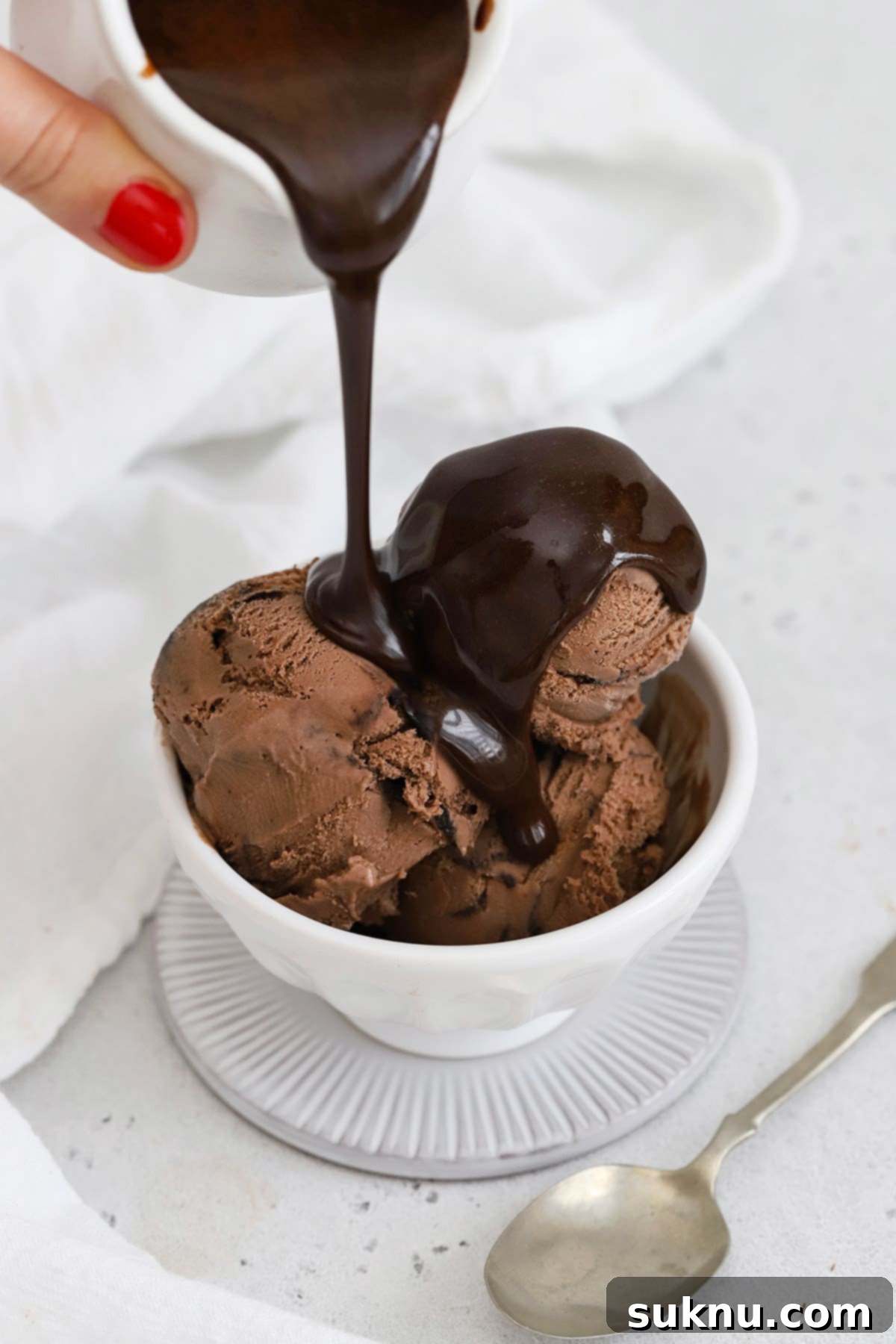 Drizzling homemade chocolate syrup over chocolate ice cream